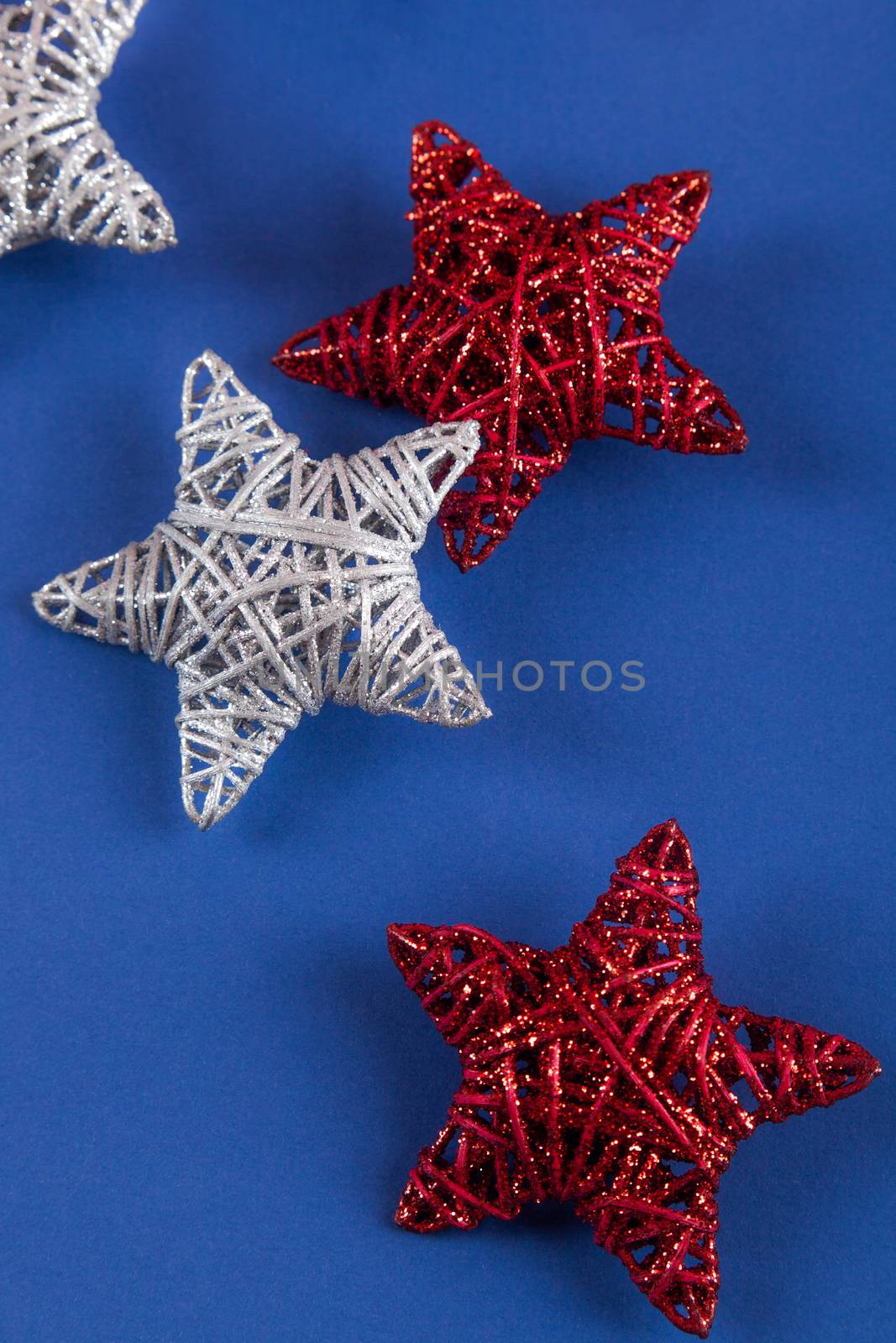 Brilliant red silver Christmas star on blue background. Use for New Year's greetings. Minimal banner, copy space for text, flatlay.
