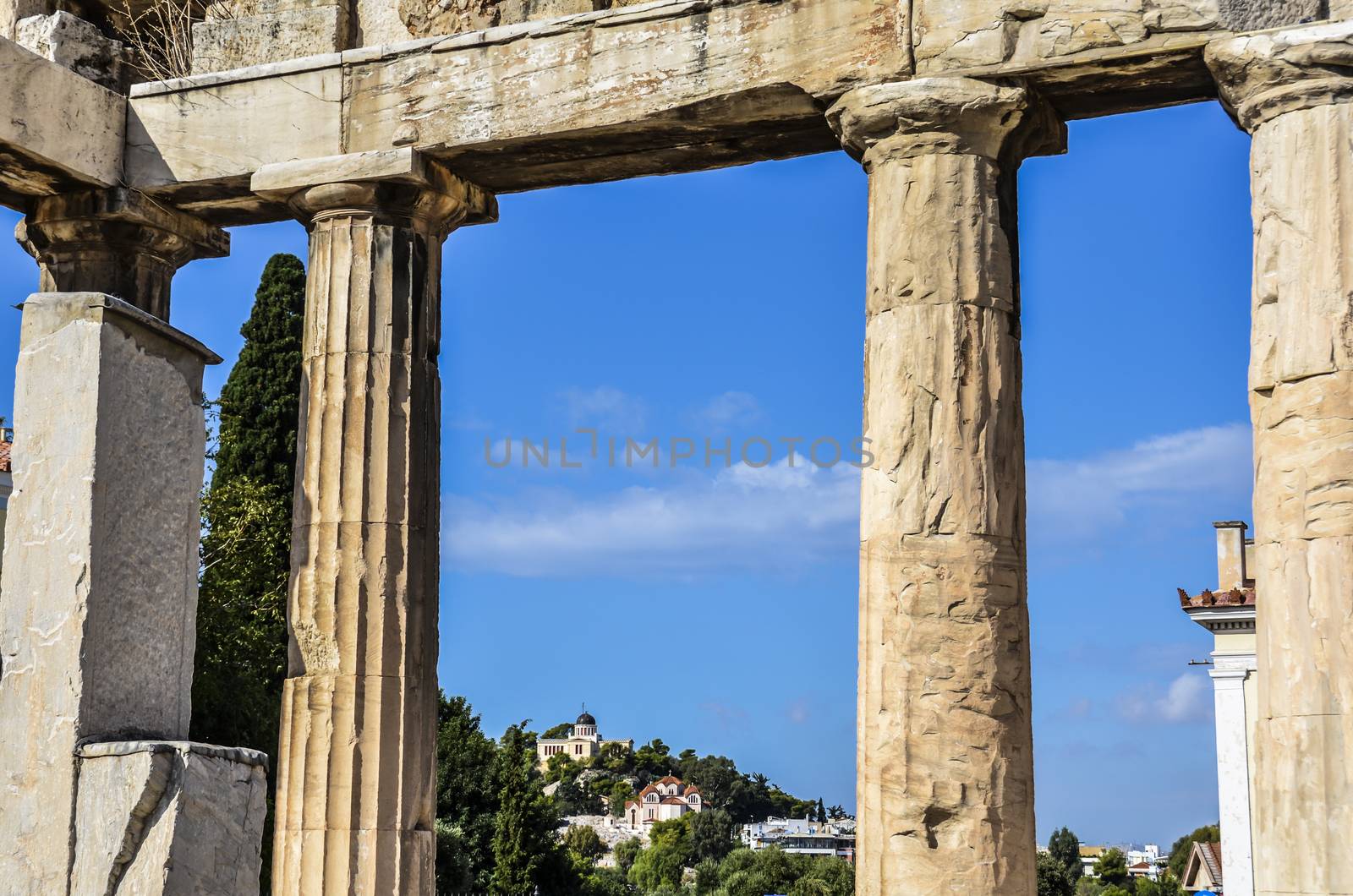 View of the National Observatory of Athens between the ancient columns of the Roman agora