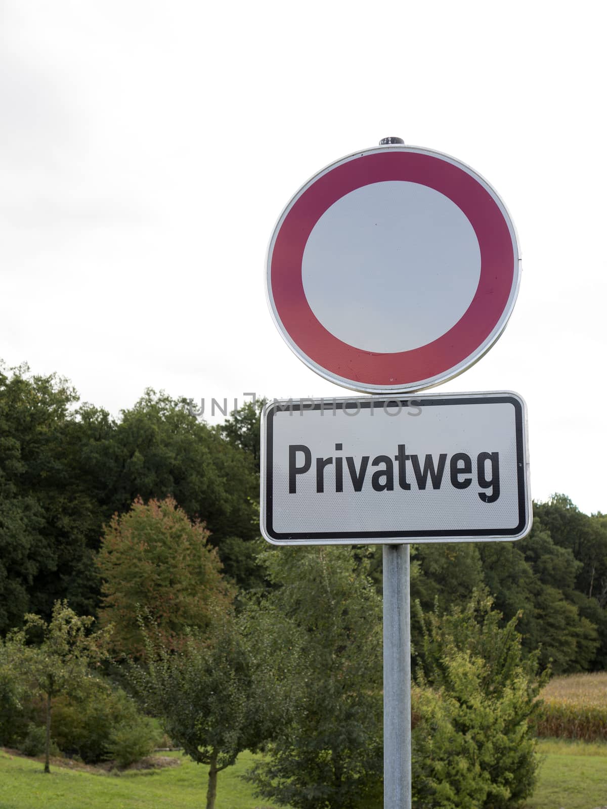 Traffic sign with German text "Privatweg" translates into "Private road" in English language