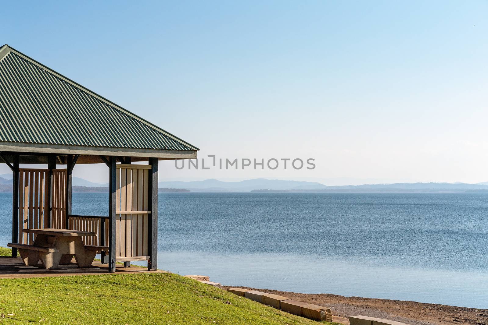 Shaded structure with verandah suitable for the public to relax at a dam popular for recreation