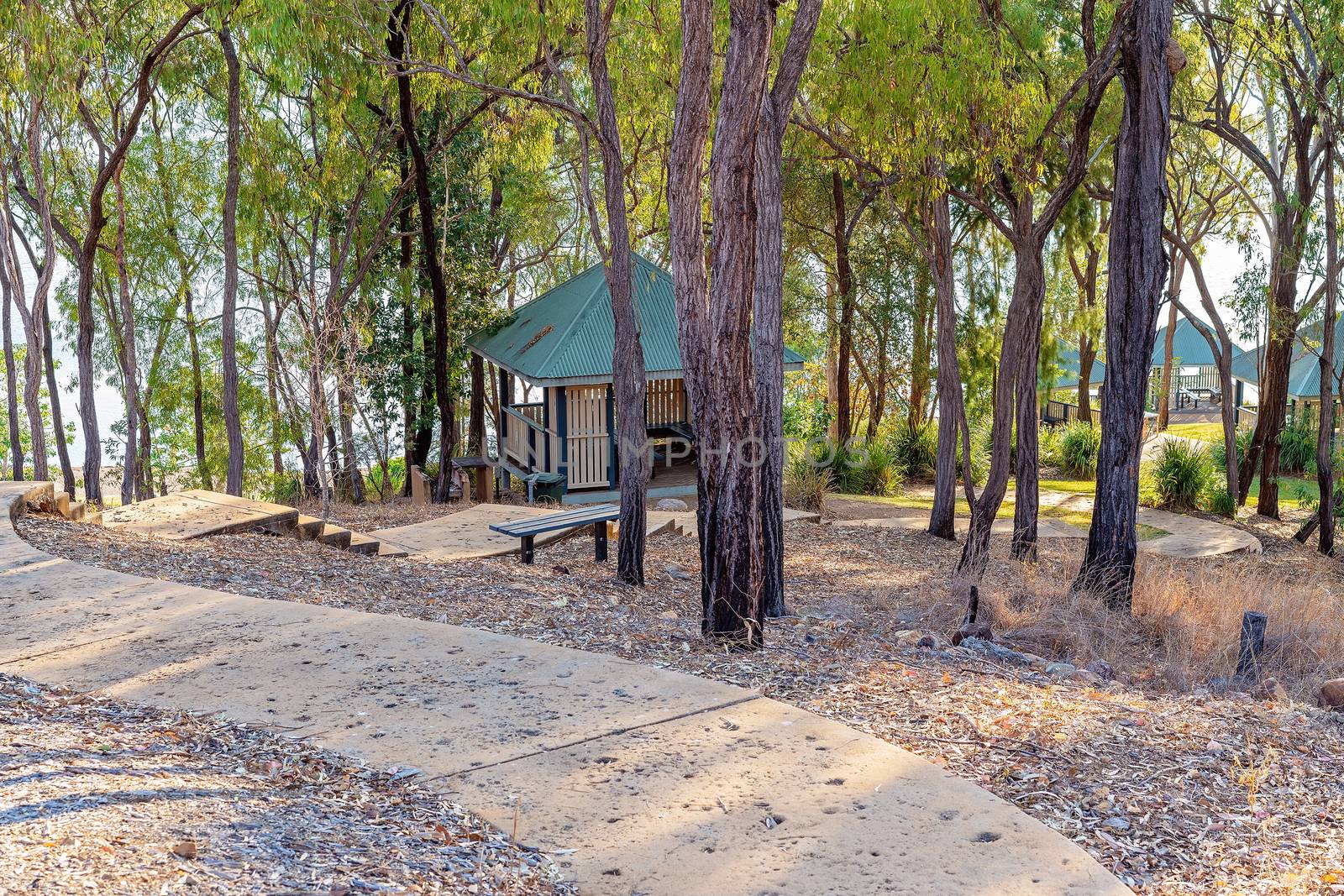 Shaded eating areas at a picturesque dam popular for recreational purposes