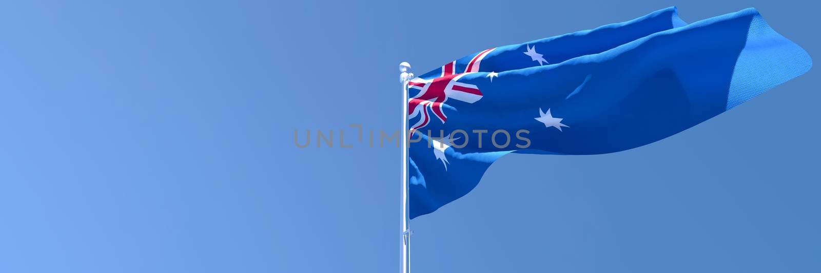 3D rendering of the national flag of Australia waving in the wind against a blue sky