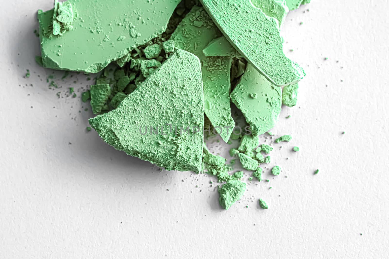 Green eye shadow powder as makeup palette closeup isolated on white background, crushed cosmetics and beauty texture by Anneleven