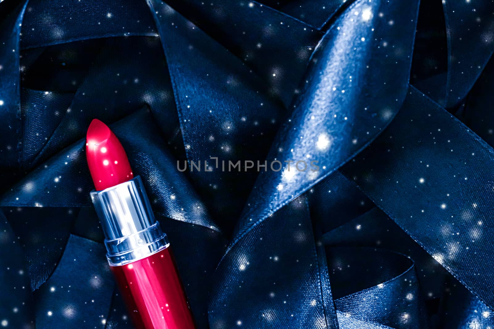 Red lipstick on blue silk and shiny glitter background, luxury make-up and beauty cosmetic by Anneleven