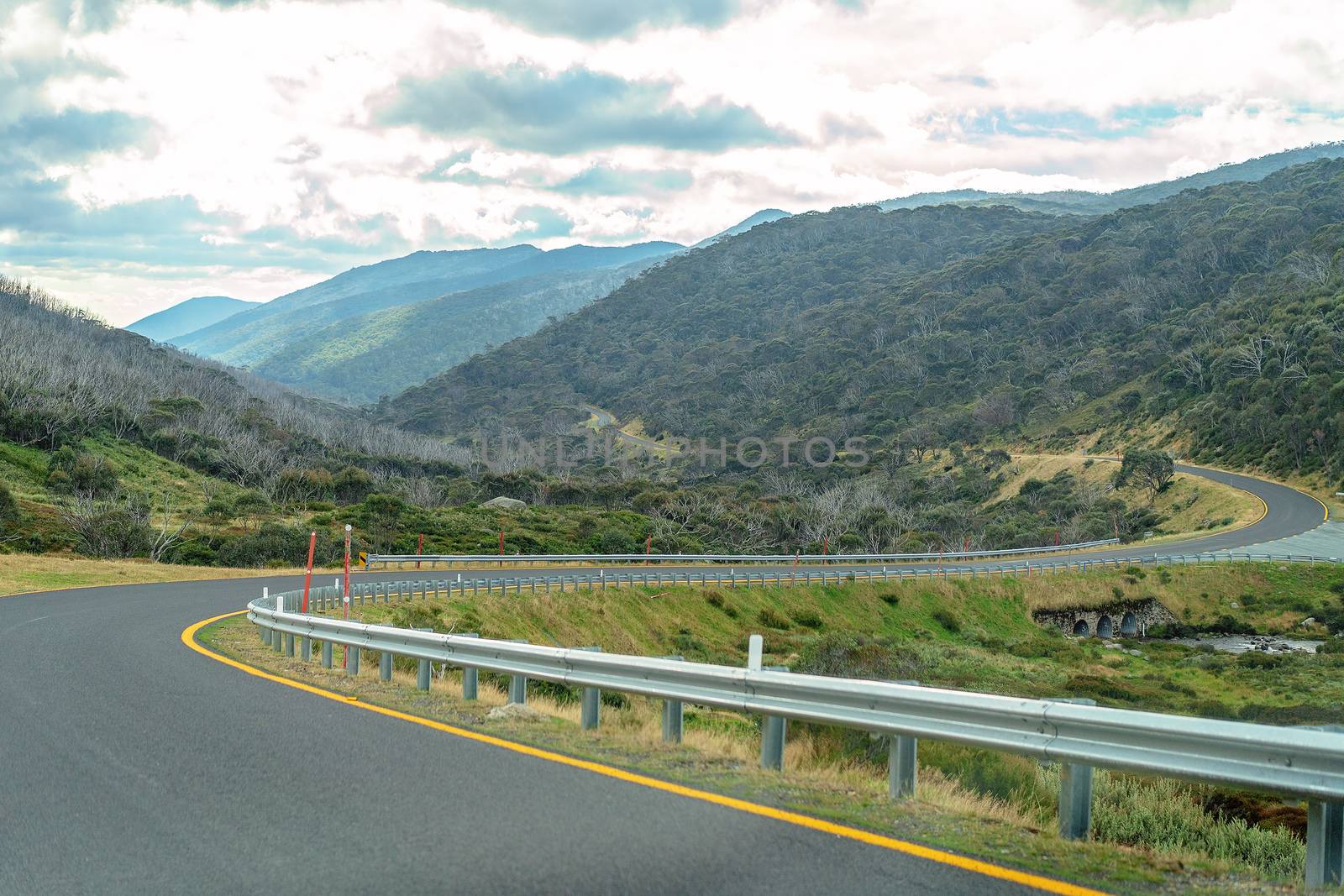 A Winding Road Through The Mountains by 	JacksonStock