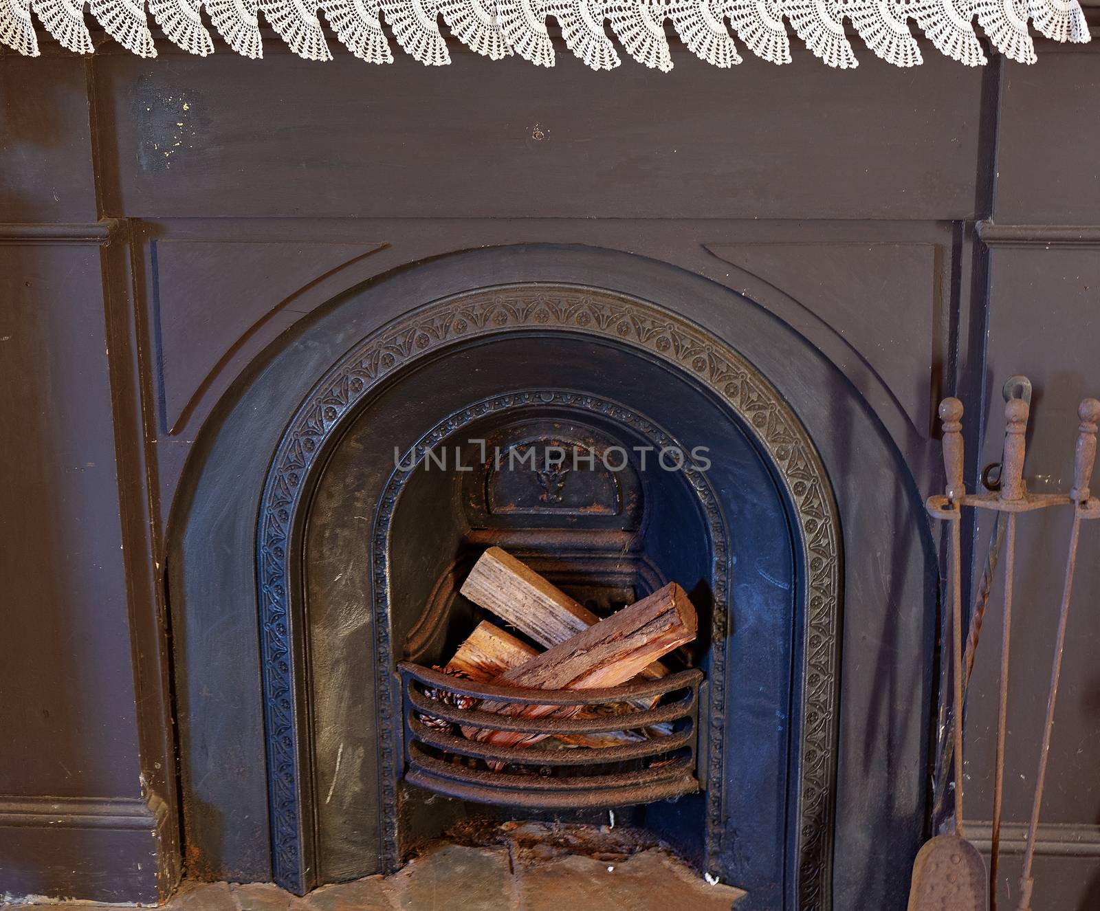 An old fashioned fireplace from 19th century Australia, complete with crochet on mantelpiece