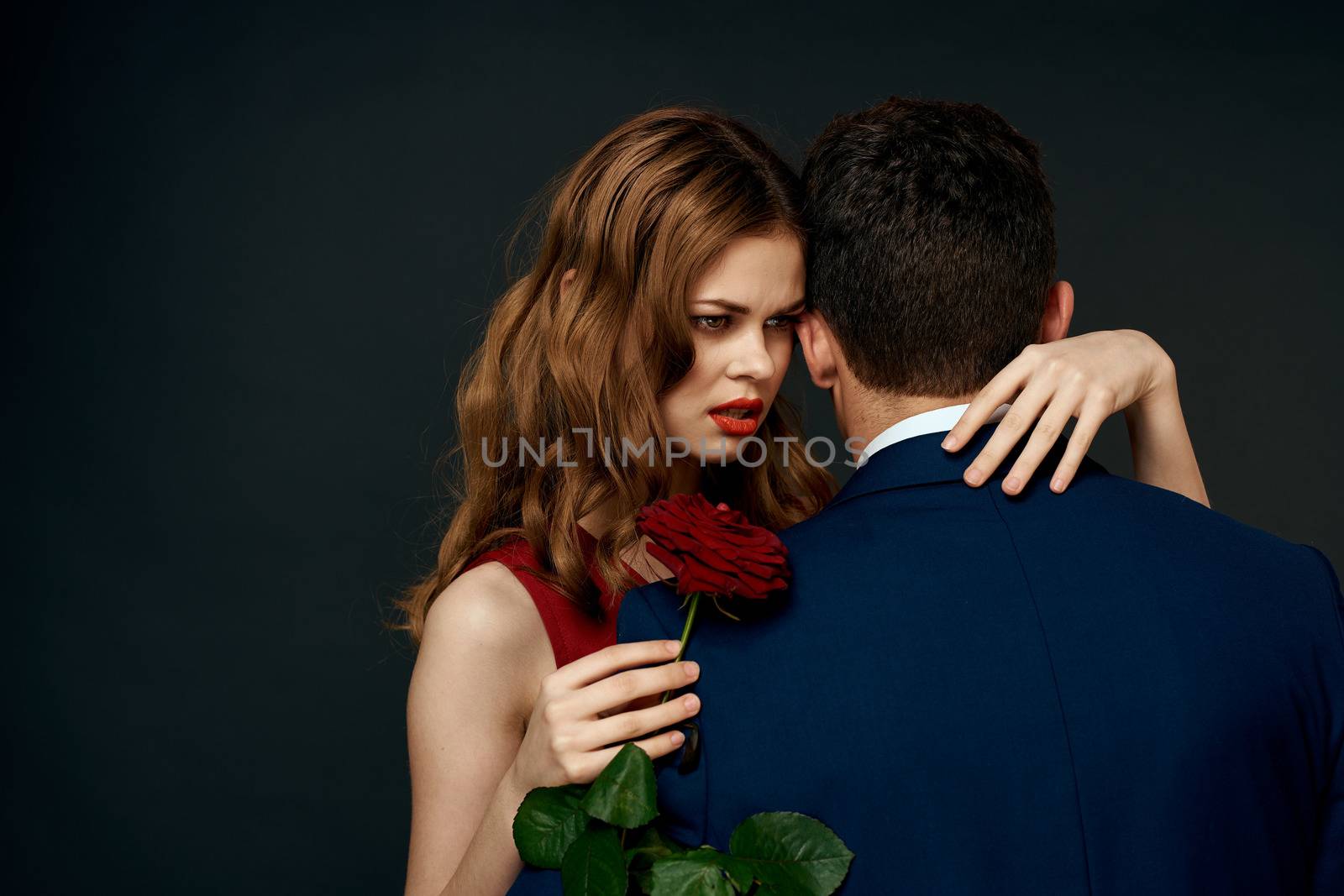 luxury couple hug romance relationship rose over dark isolated background. High quality photo