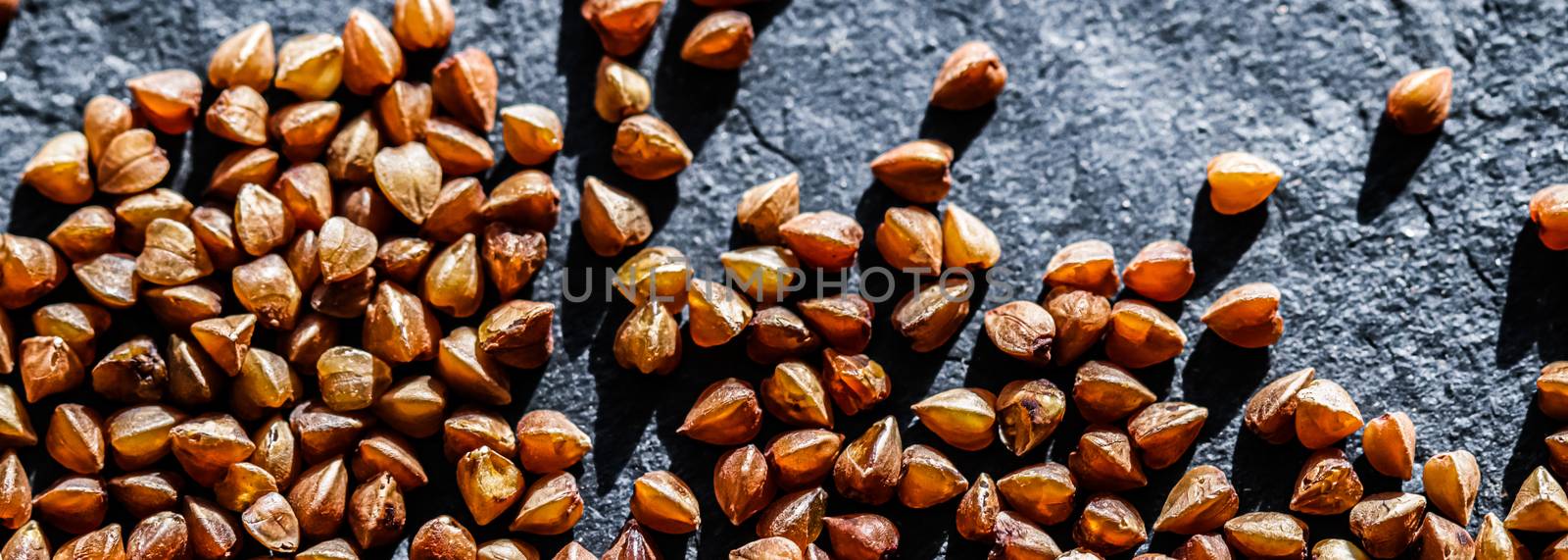 Buckwheat grain closeup, food texture and cook book background by Anneleven