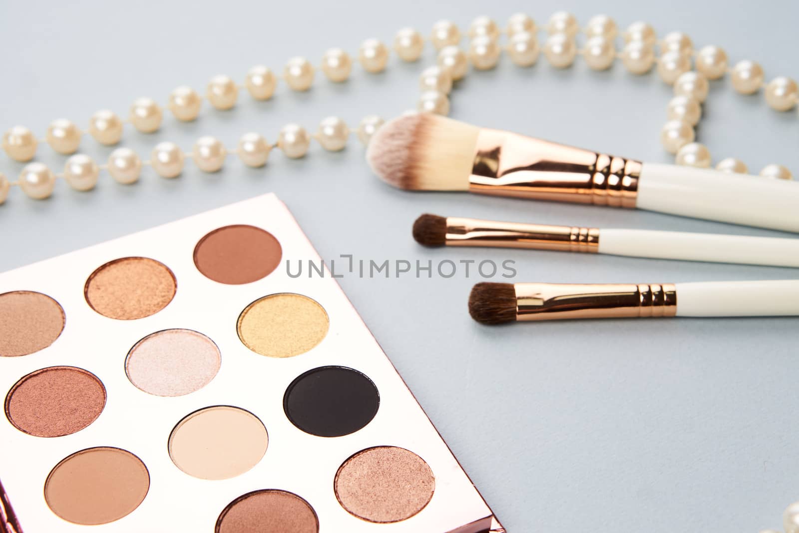 eyeshadow accessories beads makeup brushes collection professional cosmetics on gray background by SHOTPRIME