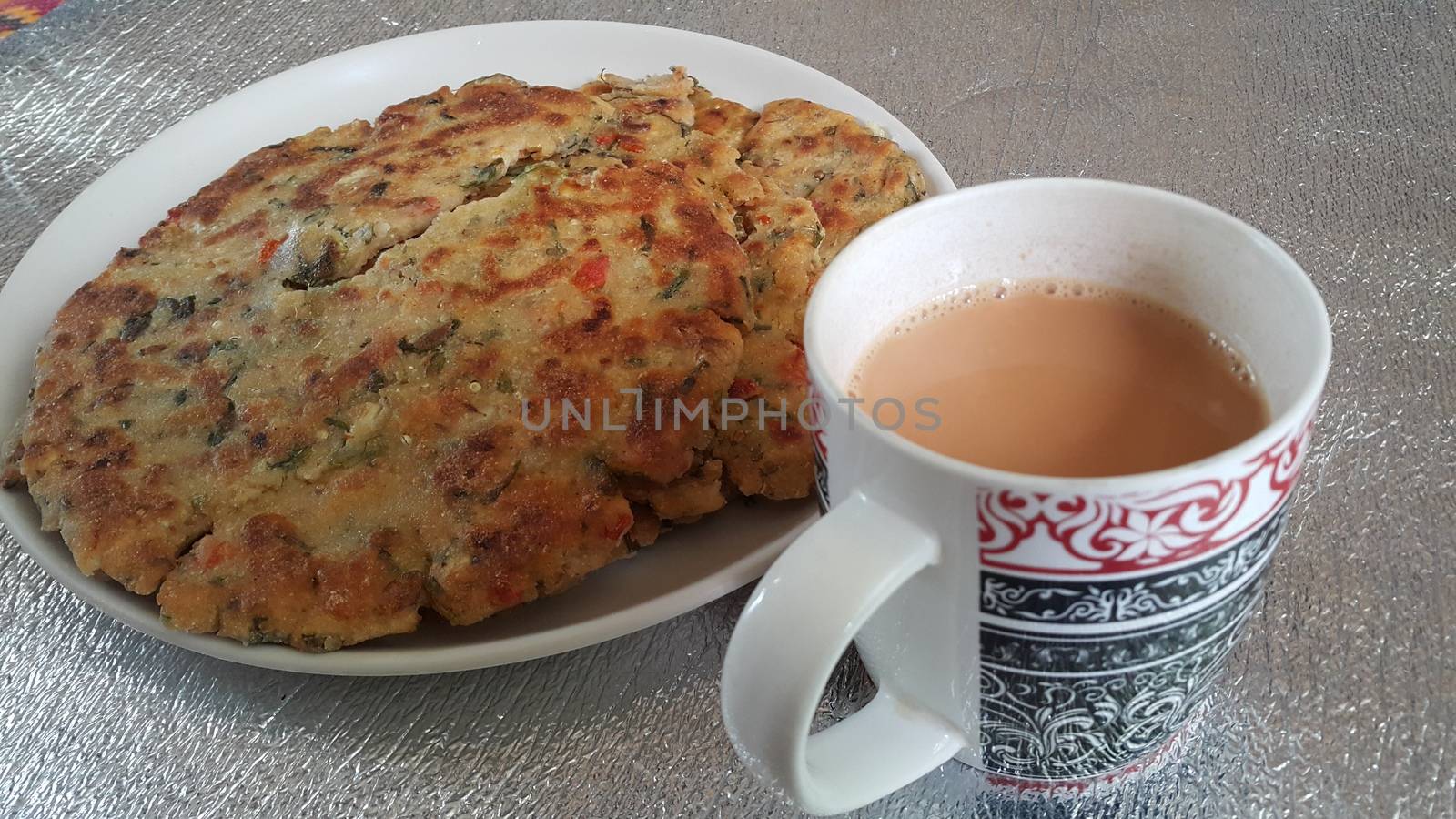 Closeup view of of traditional bread called Jawar roti or bhakri with tea cup. Bhakri is a round flat unleavened bread often used in the cuisine of many Asian countries
