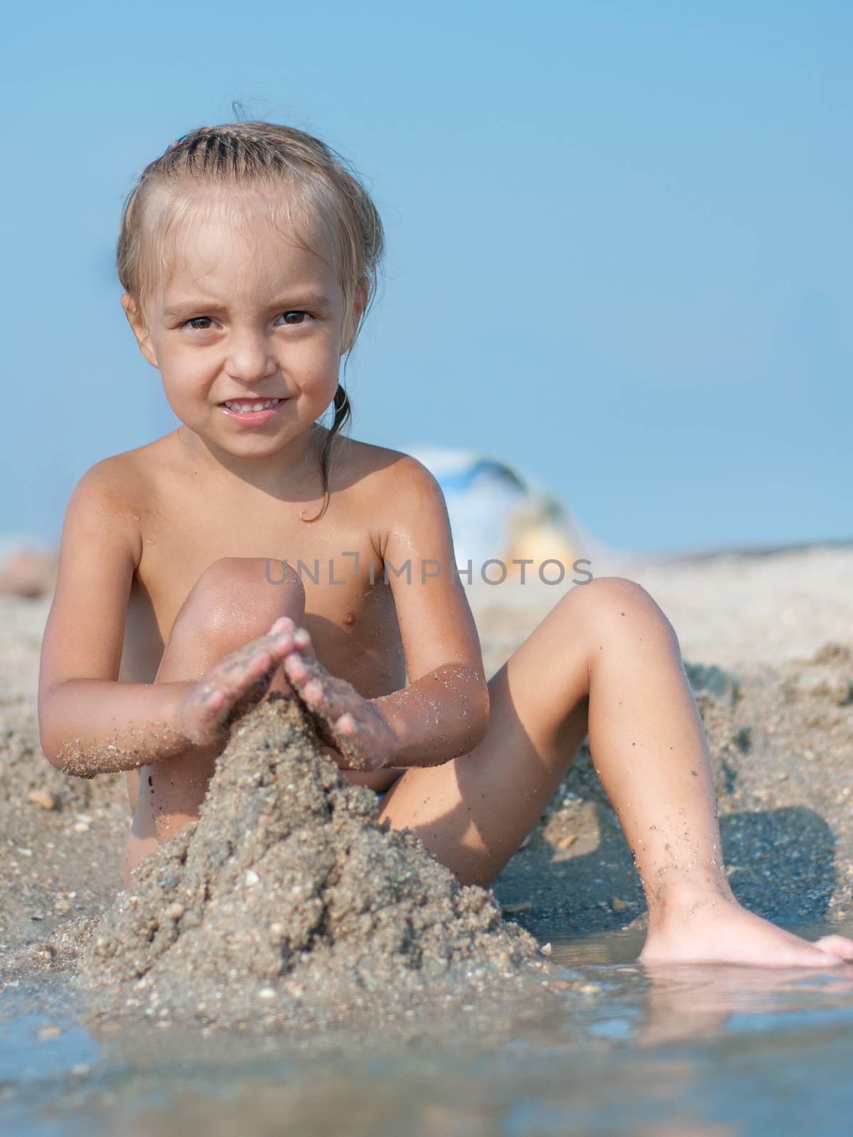 Little girl on sandy beach by fotostok_pdv