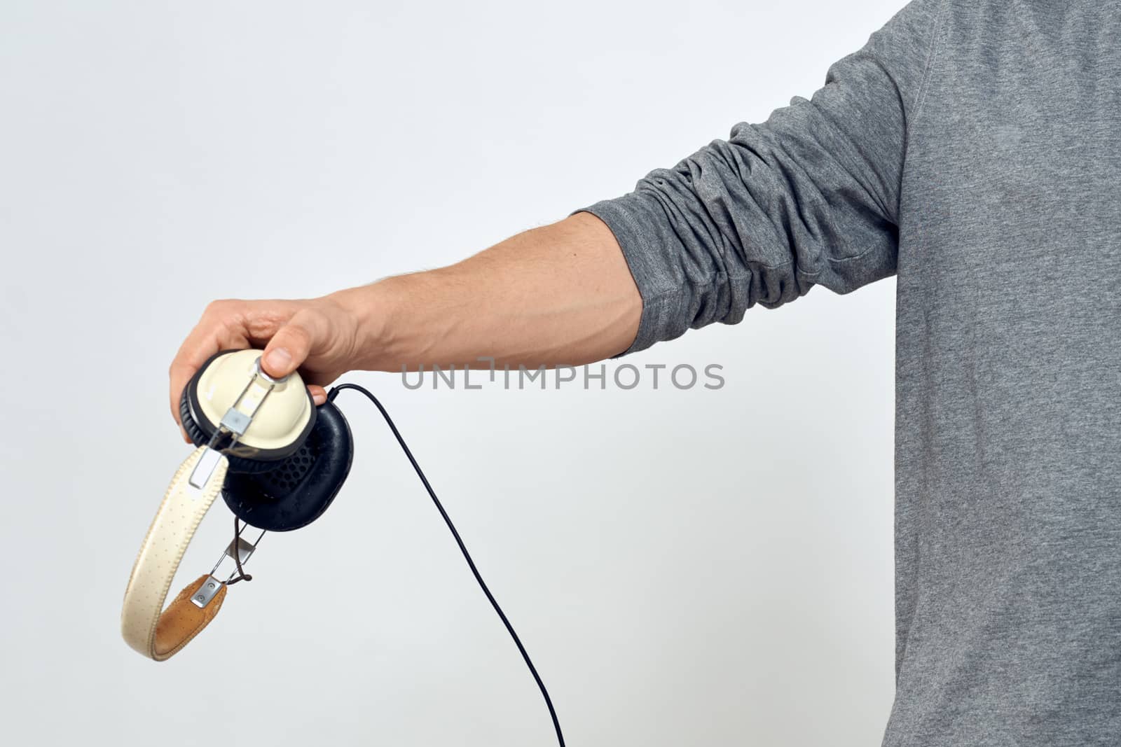 Man holding headphones in the hands of a man lifestyle modern style technology cropped view. High quality photo