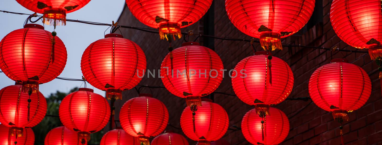 Beautiful round red lantern hanging on old traditional street, concept of Chinese lunar new year festival in Taiwan, close up. The undering word means blessing.