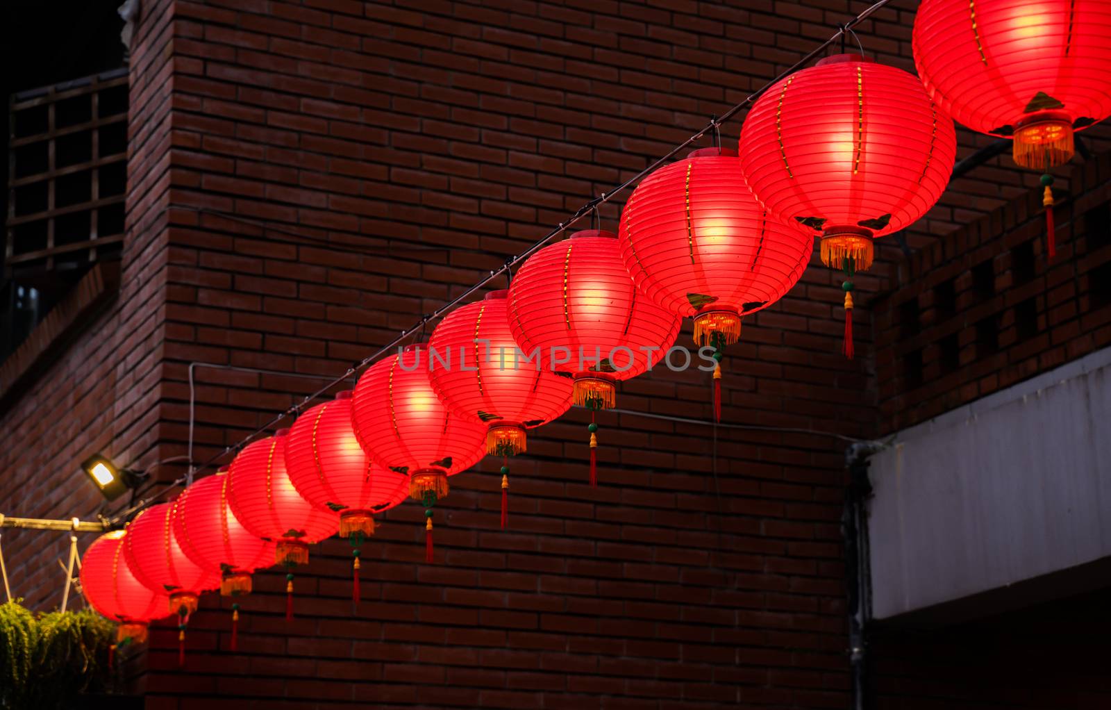 Beautiful round red lantern hanging on old traditional street, concept of Chinese lunar new year festival in Taiwan, close up. The undering word means blessing.