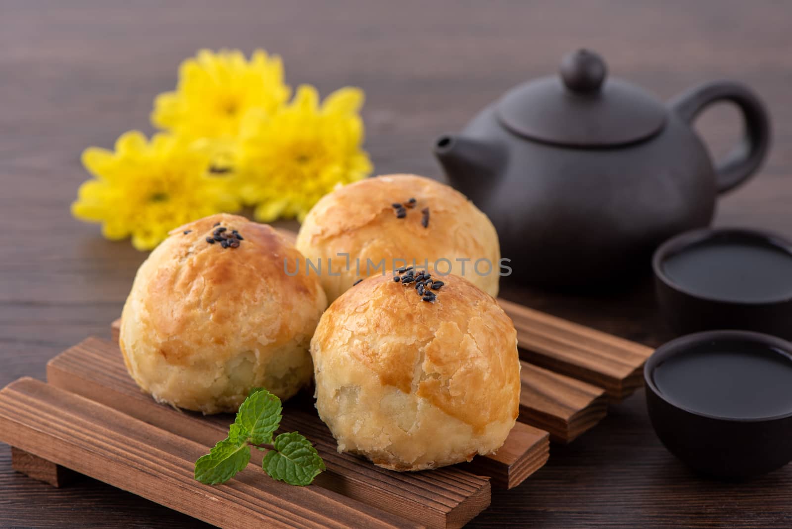 Moon cake yolk pastry, mooncake for Mid-Autumn Festival holiday, top view design concept on dark wooden table with copy space, flat lay, overhead shot