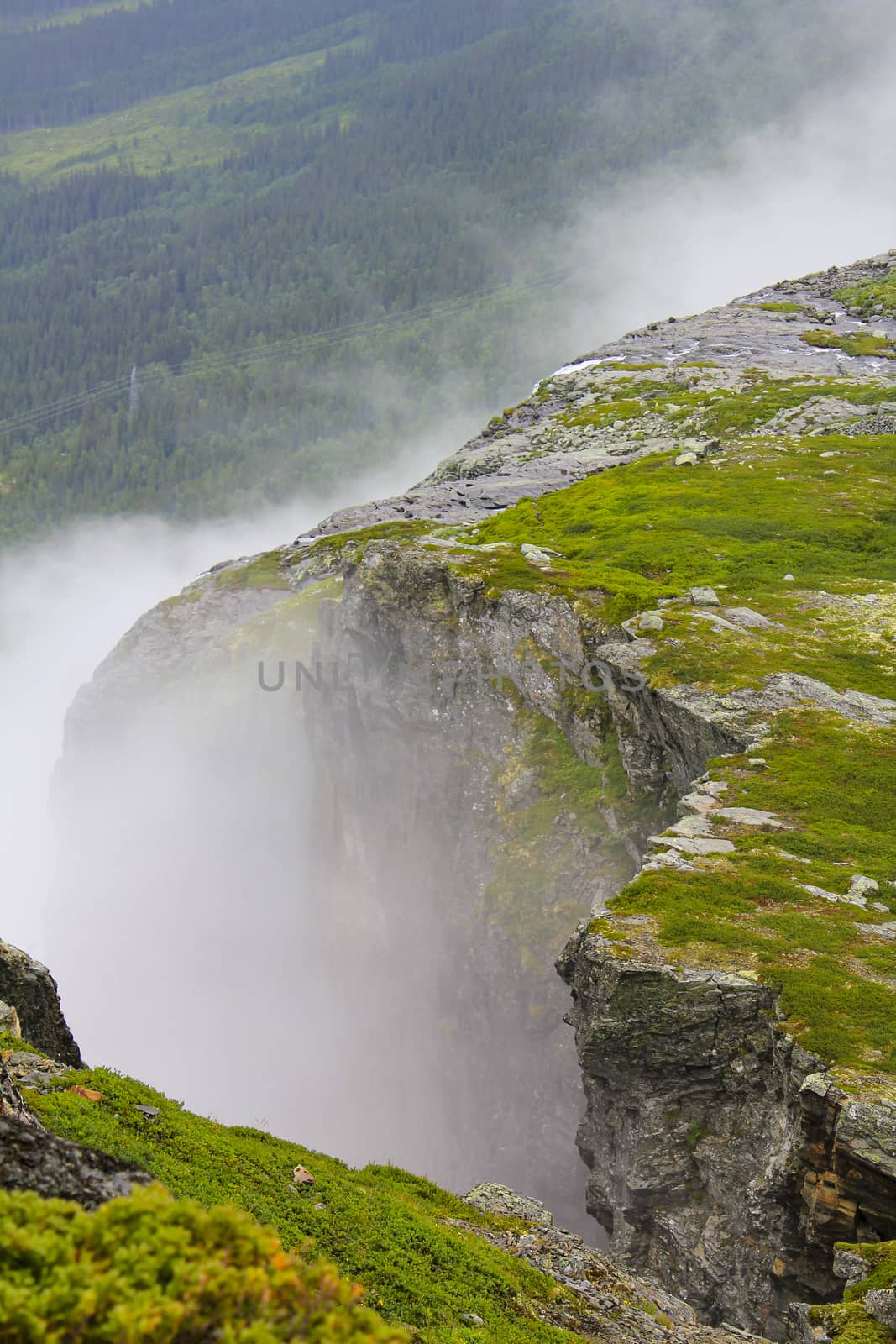 Fog, clouds, rocks and cliffs on Veslehødn Veslehorn mountain in Hemsedal, Norway.