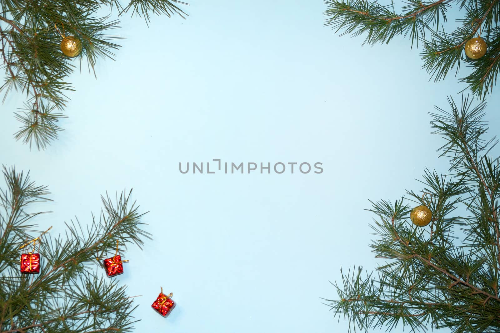 coniferous branches and Christmas tree decorations on a New Year's blue background, copy space