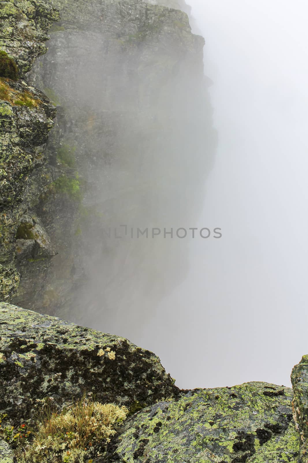 Fog, clouds, rocks and cliffs on Veslehødn Veslehorn mountain in Hemsedal, Norway.