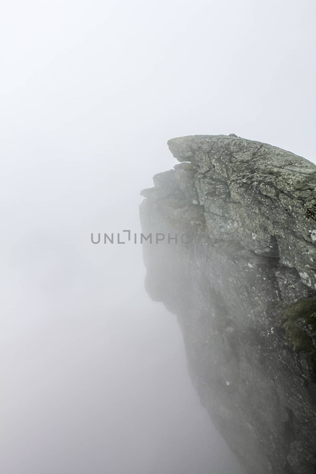 Fog, clouds, rocks and cliffs on Veslehødn Veslehorn mountain in Hemsedal, Norway.