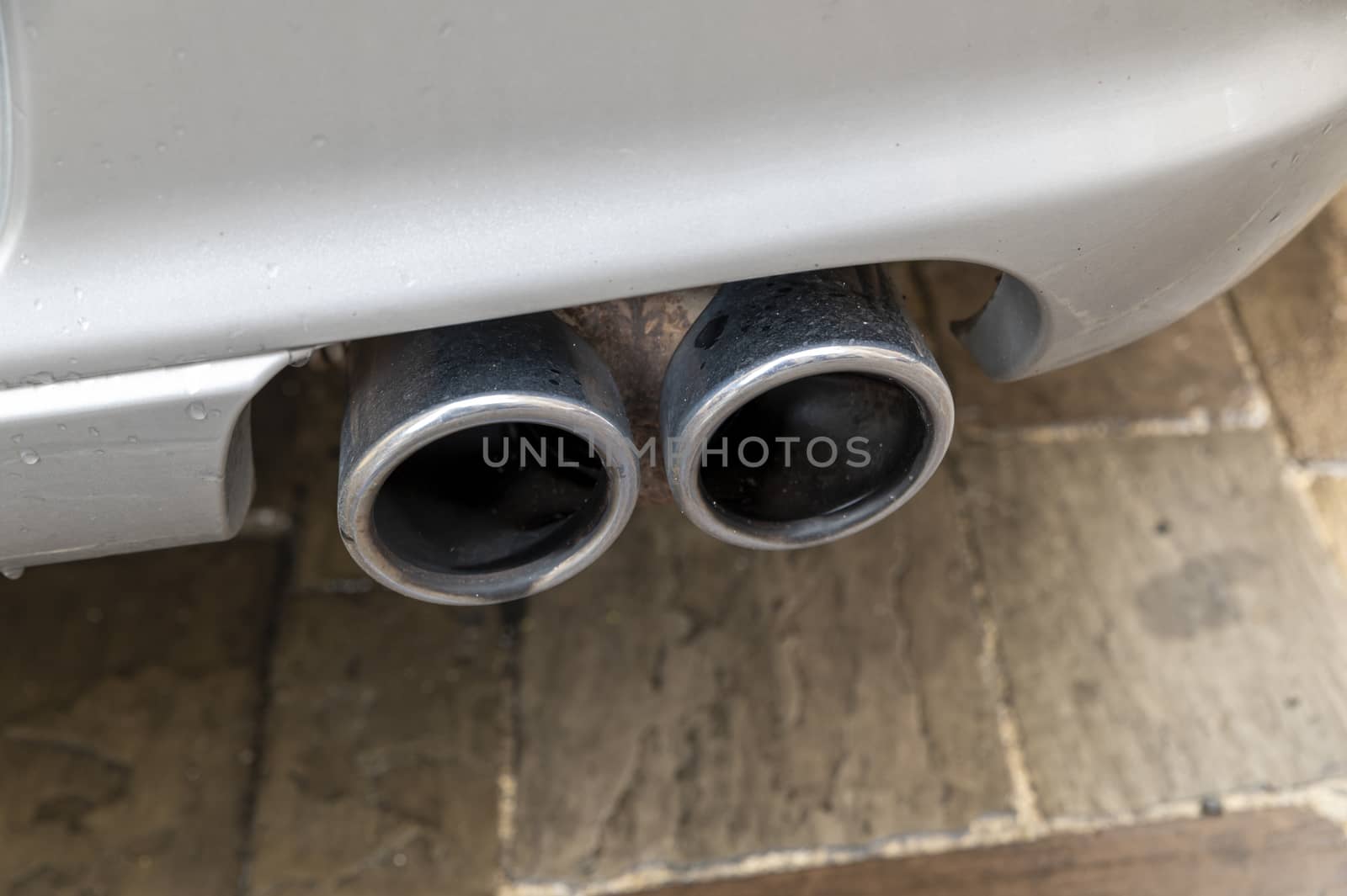 detail of a chrome exhaust of a parked sports car