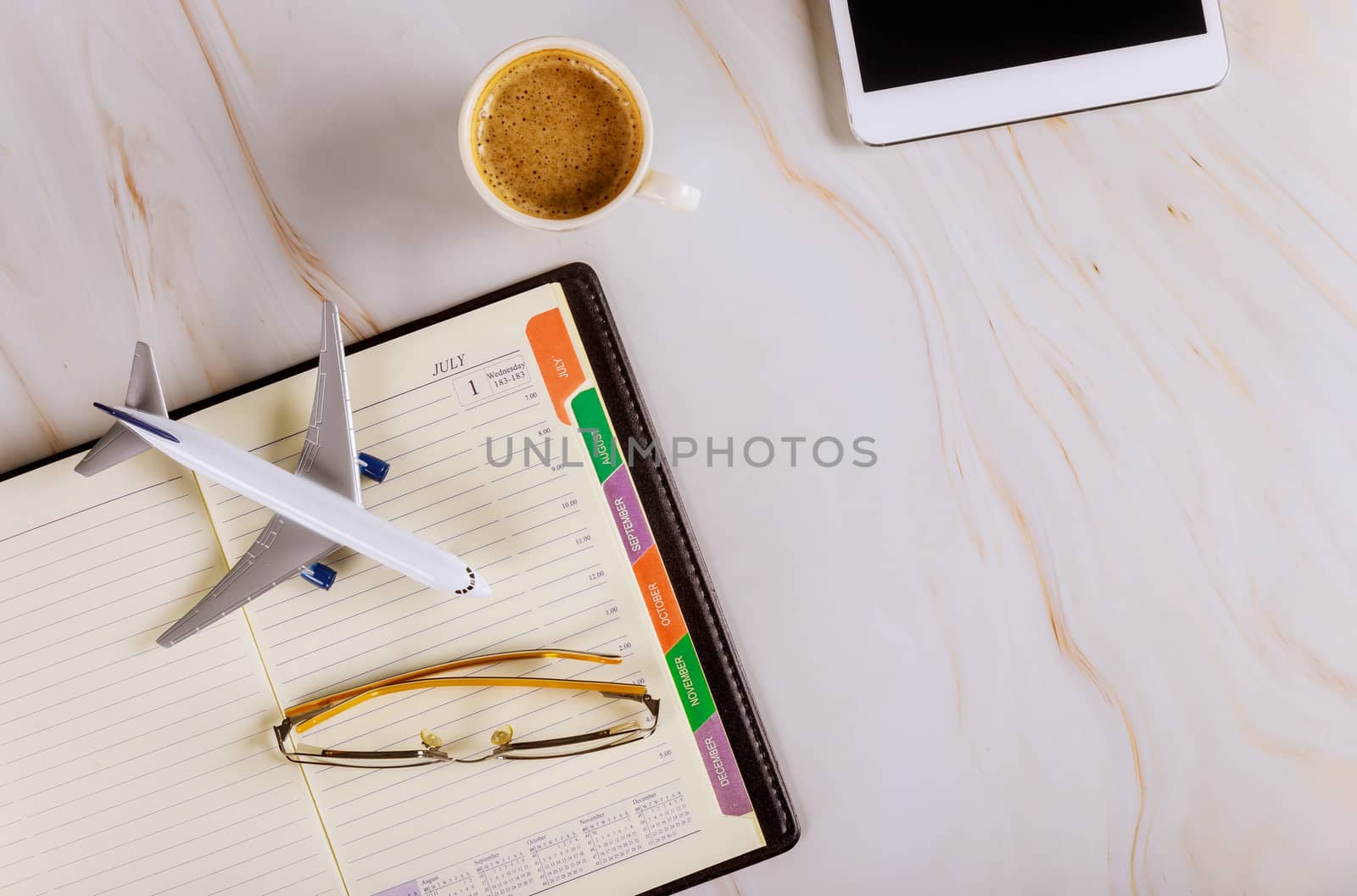 Travel office desk with notebook, glasses cup of coffee digital tablet view from above