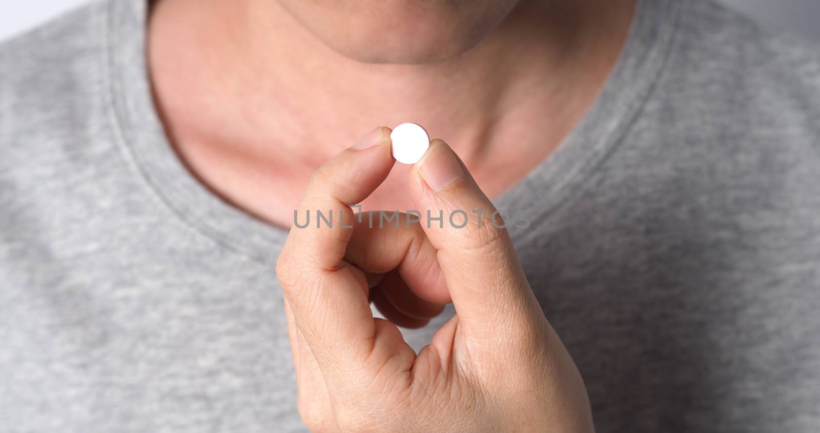 Close-up images of people taking or holding a medicine pill in hand which help and protect from pandemic virus and relief them from unhealthy and sickness. studio shot and clear background.