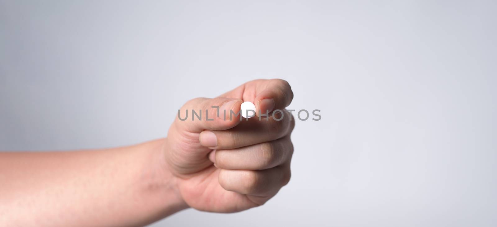 Close-up images of people taking or holding a medicine pill in hand which help and protect from pandemic virus and relief them from unhealthy and sickness. studio shot and clear background.