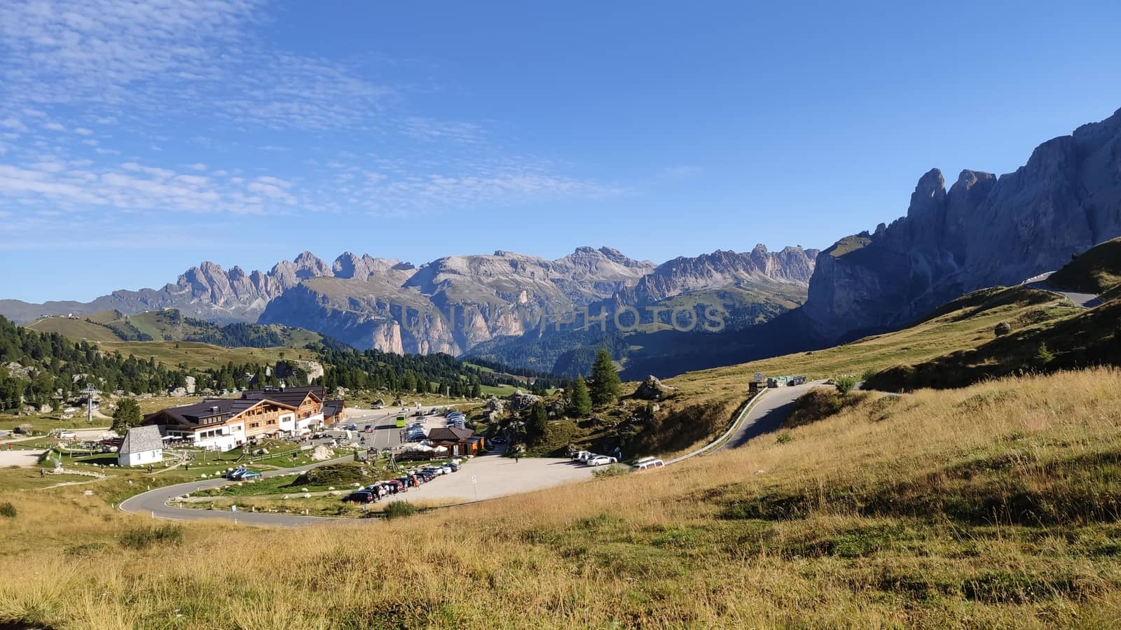 Val Gardena, Italy - 09/15/2020: Scenic alpine place with magical Dolomites mountains in background, amazing clouds and blue sky in Trentino Alto Adige region, Italy, Europe