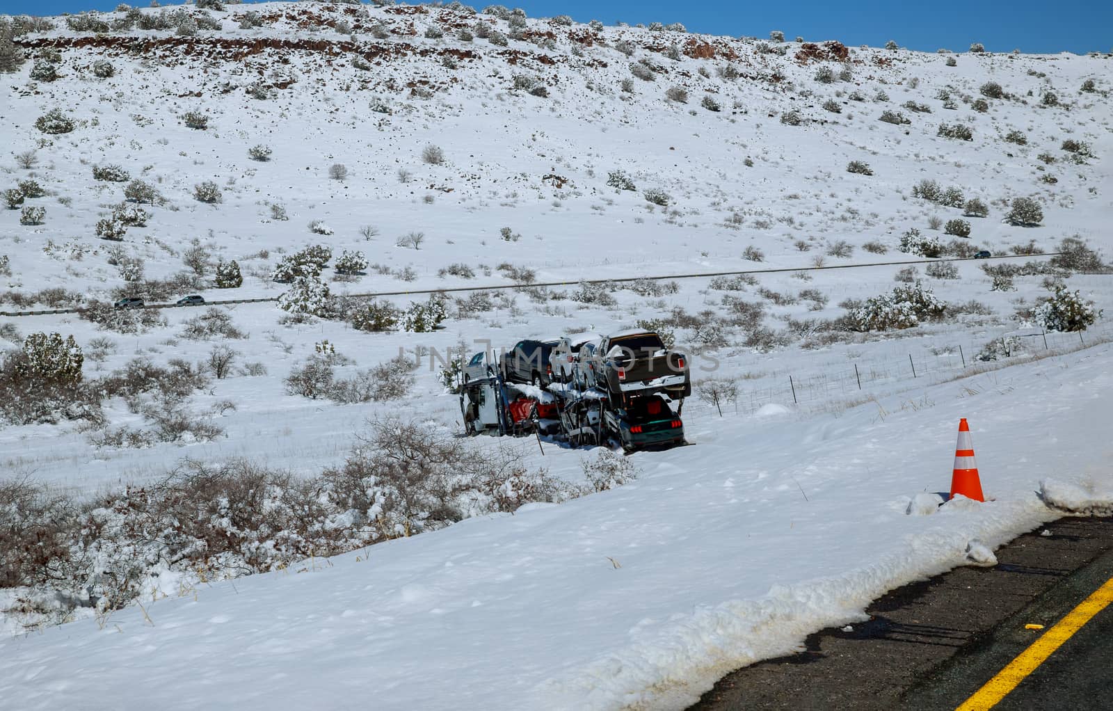 Drift of the car carrier trailer truck on the winter road because of snowy mountain road in winter