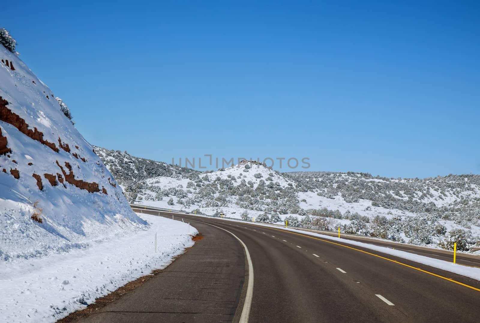Empty asphalt road with snow mountains covered snow