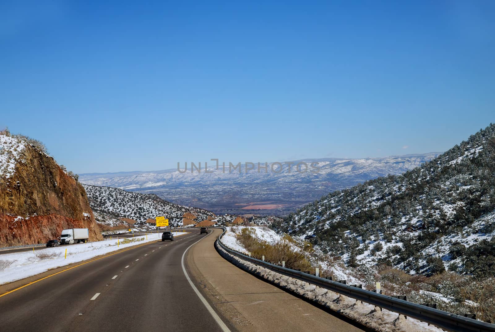 Snow capped mountains in Colorado snow covered roadway