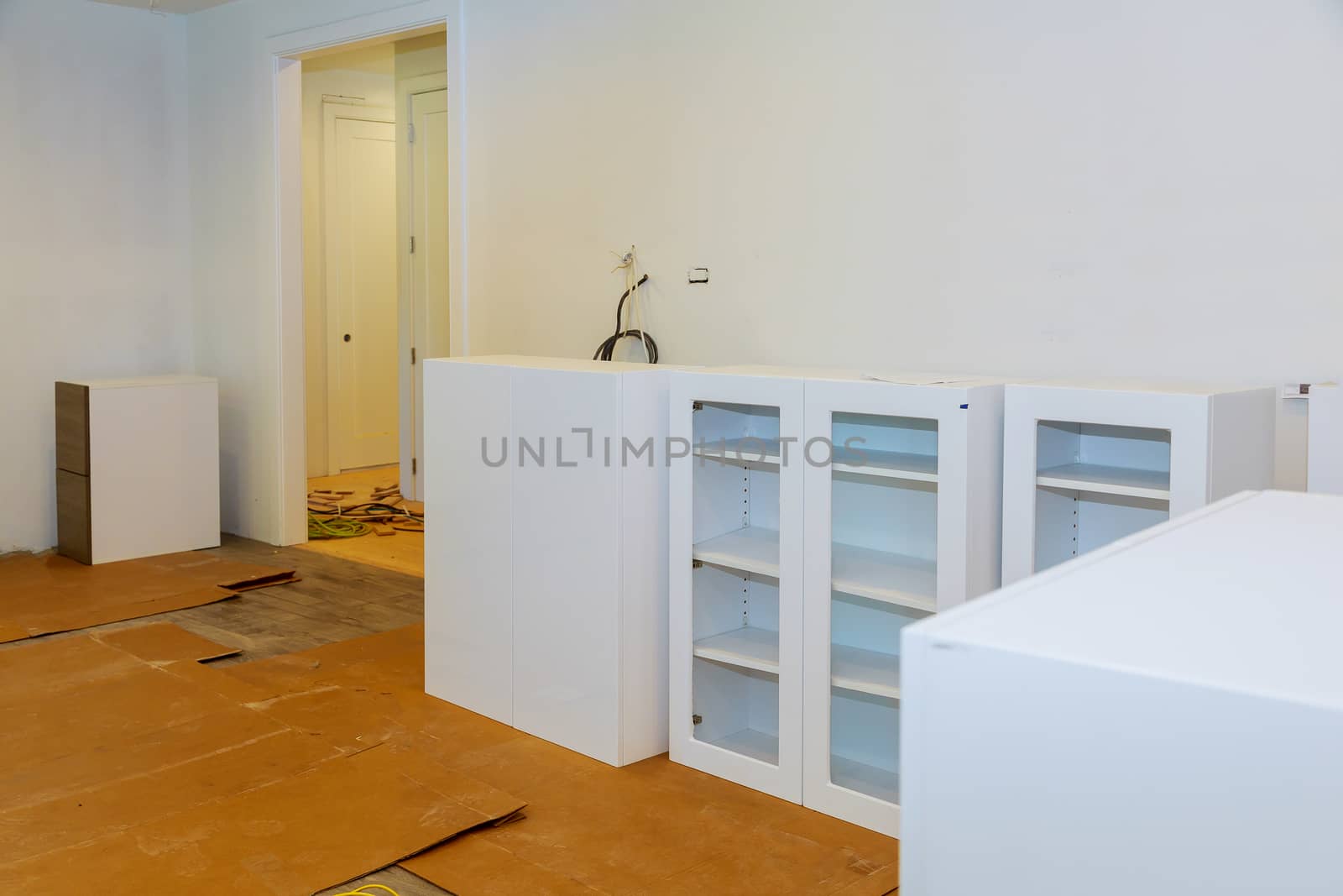 Modern domestic cabinets with new appliances and sink in kitchen by ungvar