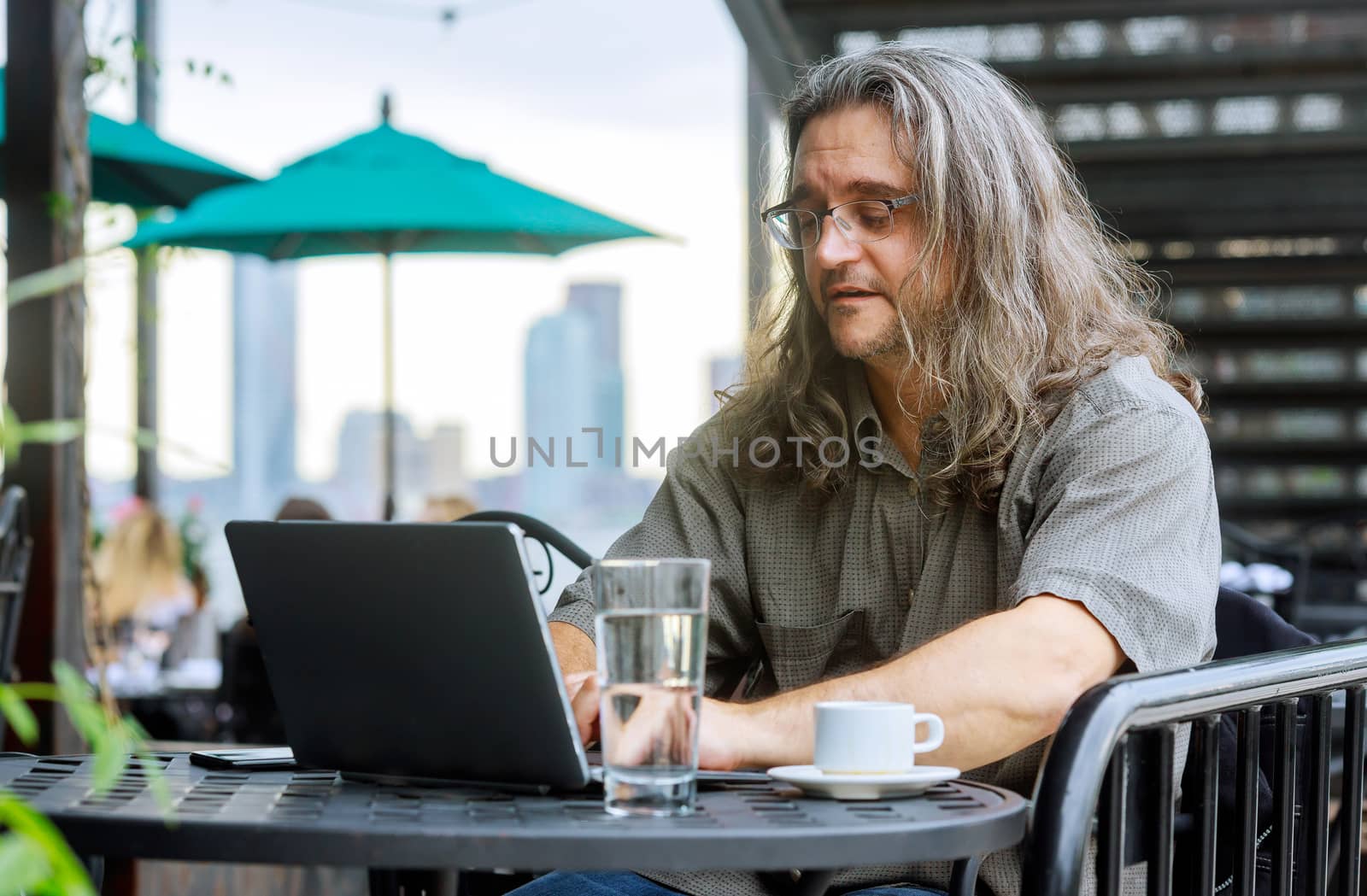 Man working with laptop in the table in coffee shop a cup of coffee