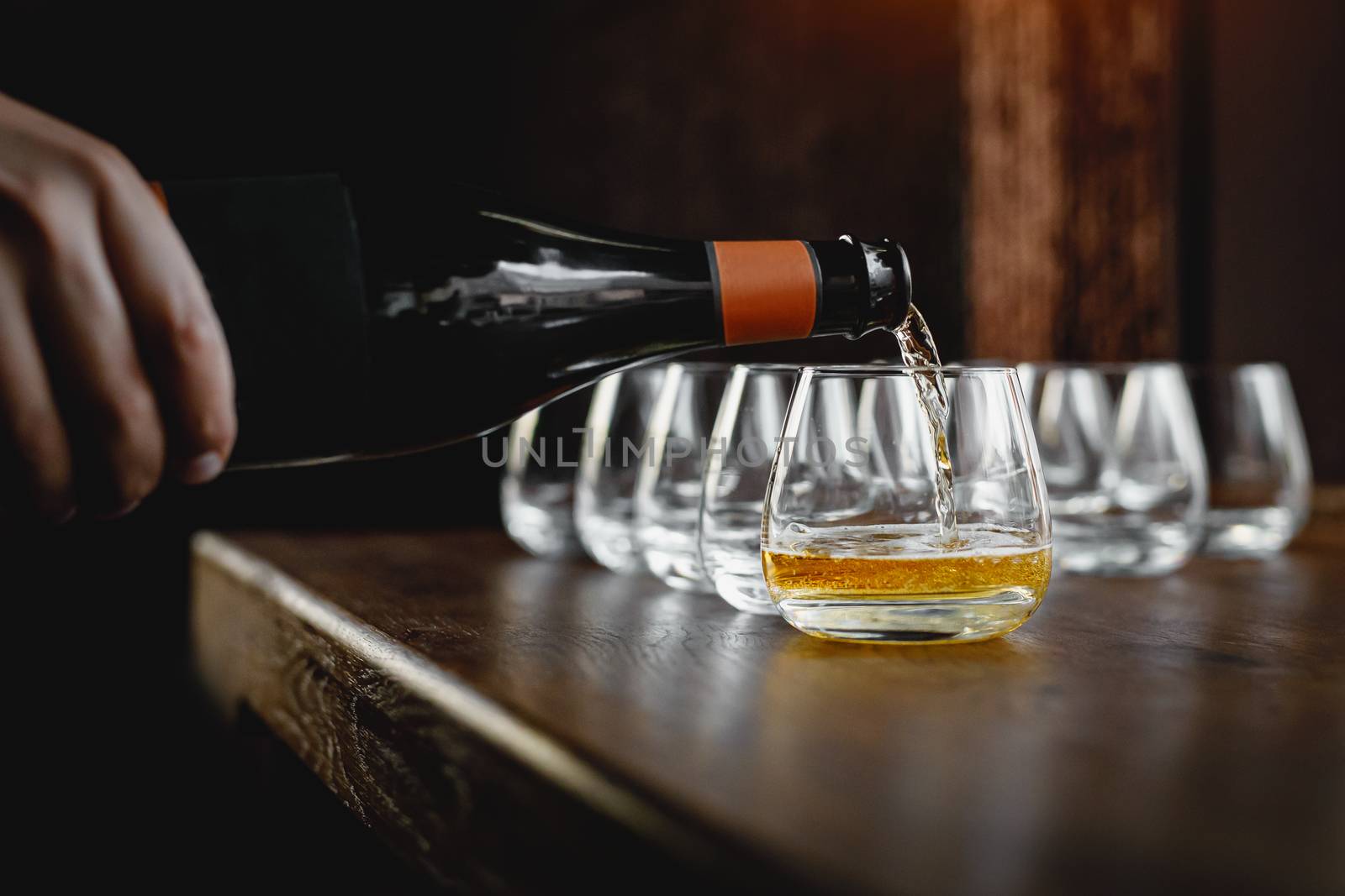 Pouring cider into glass from bottle