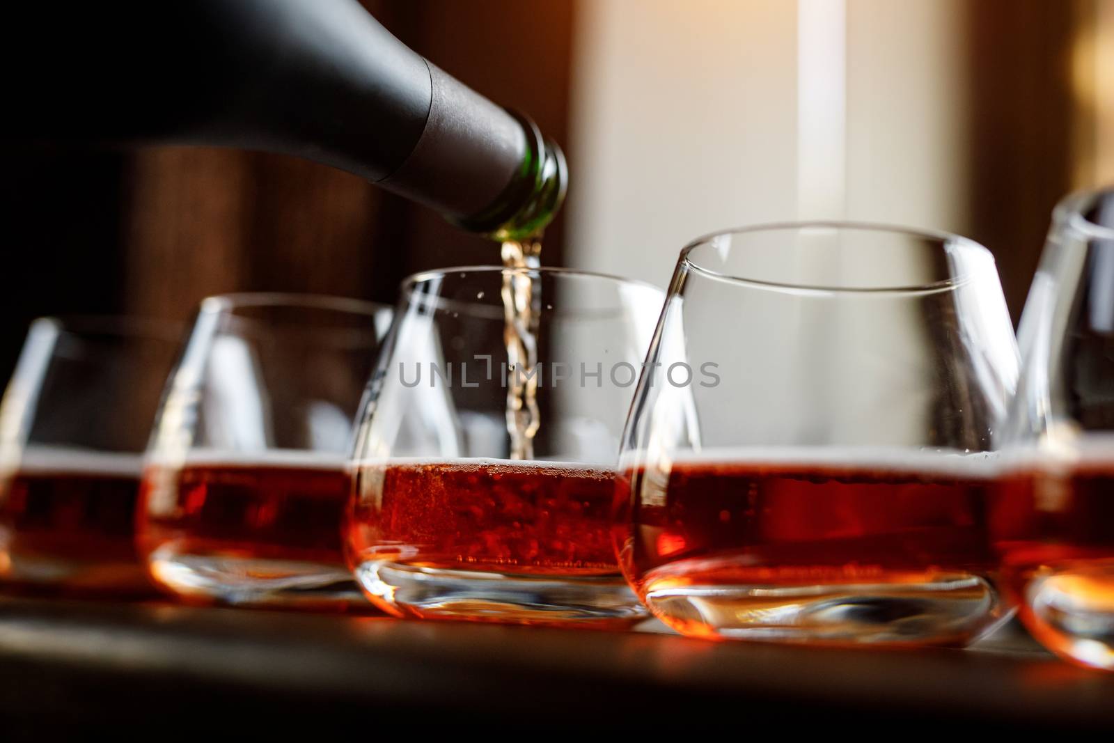 Pouring cider into glass from bottle