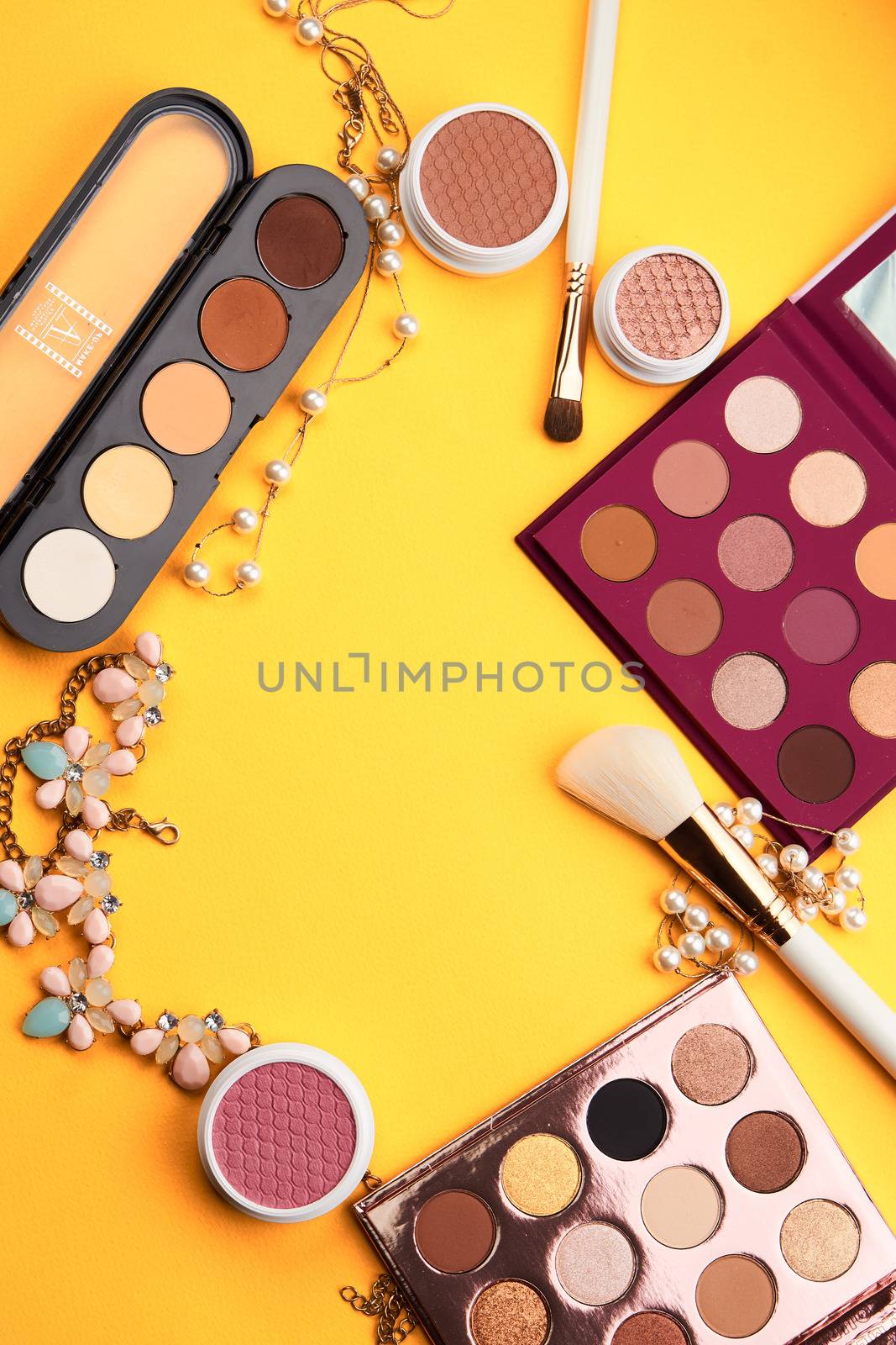 eyeshadow professional cosmetics blush powder yellow background top view. High quality photo