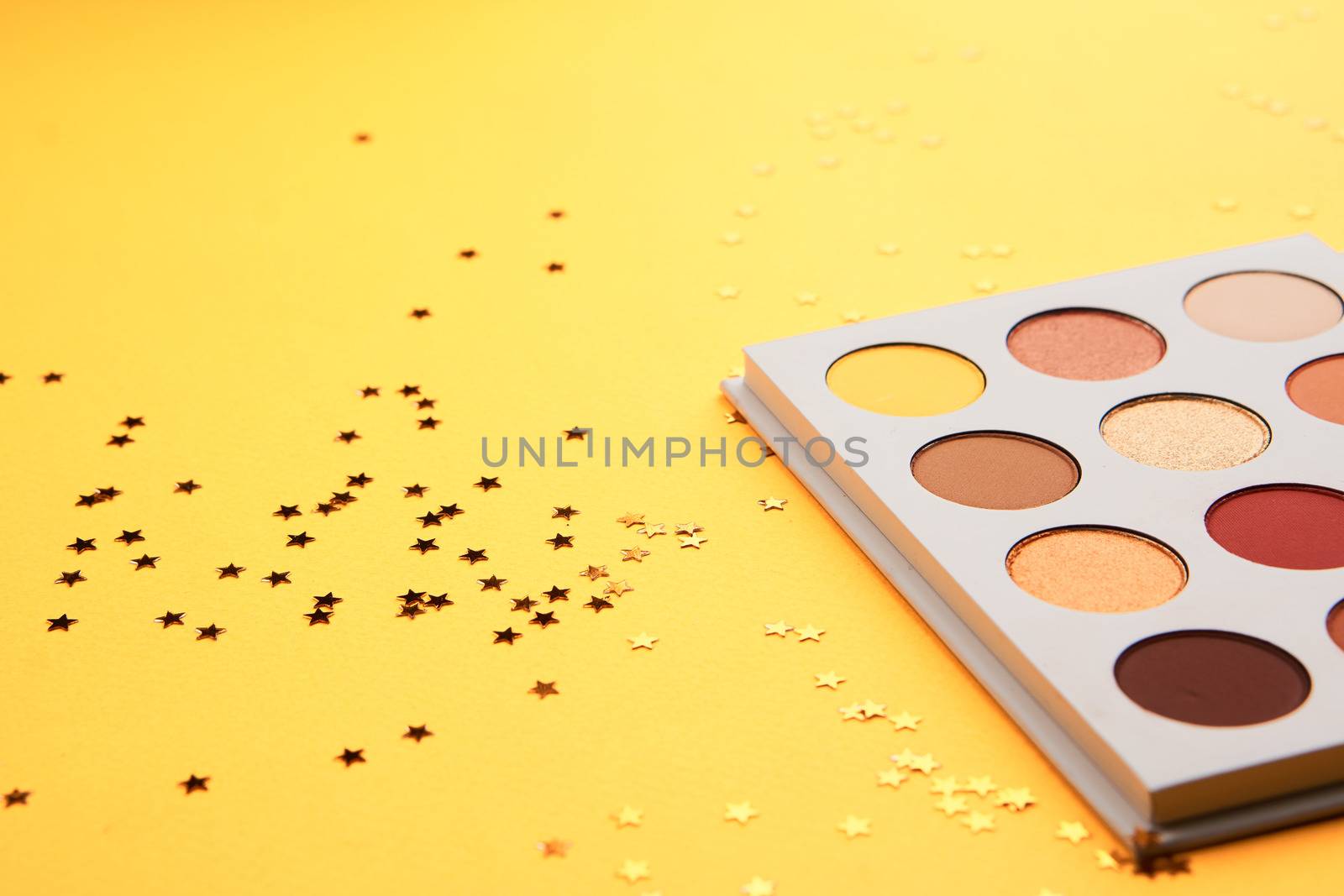 Eyeshadows on a yellow background professional cosmetics makeup brushes soft sponge fashion glasses by SHOTPRIME