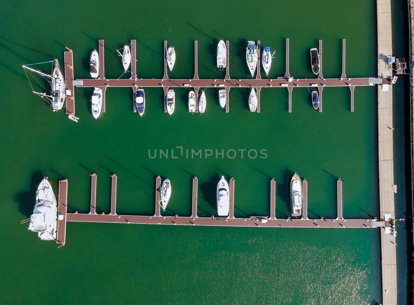 Aerial over small marina on a dock basin in small harbor, aerial view by ungvar