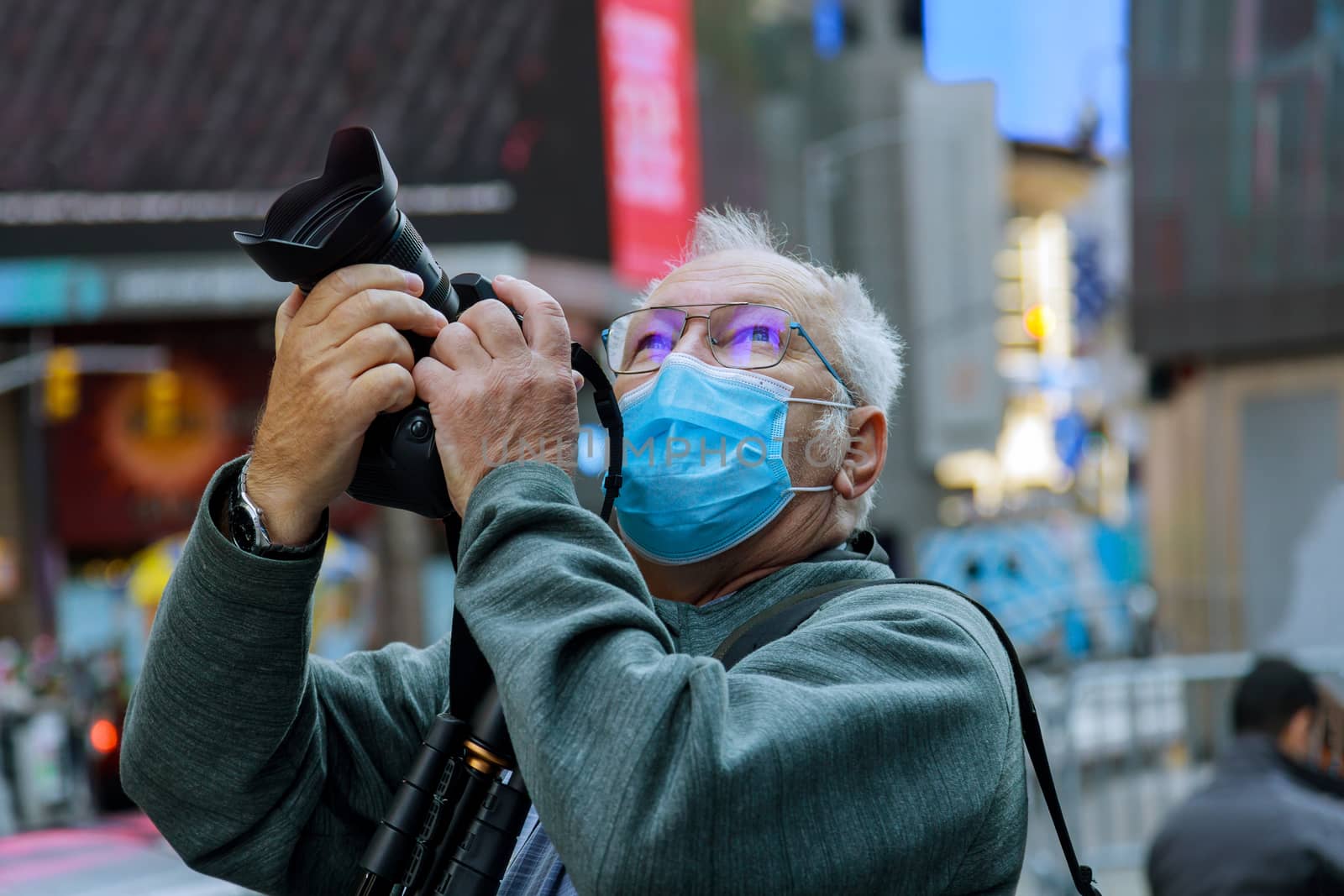 Travelling in American city The new normal tourism with mask middle aged man takes a picture of the New York by ungvar