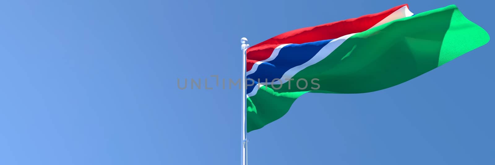 3D rendering of the national flag of Gambia waving in the wind against a blue sky by butenkow