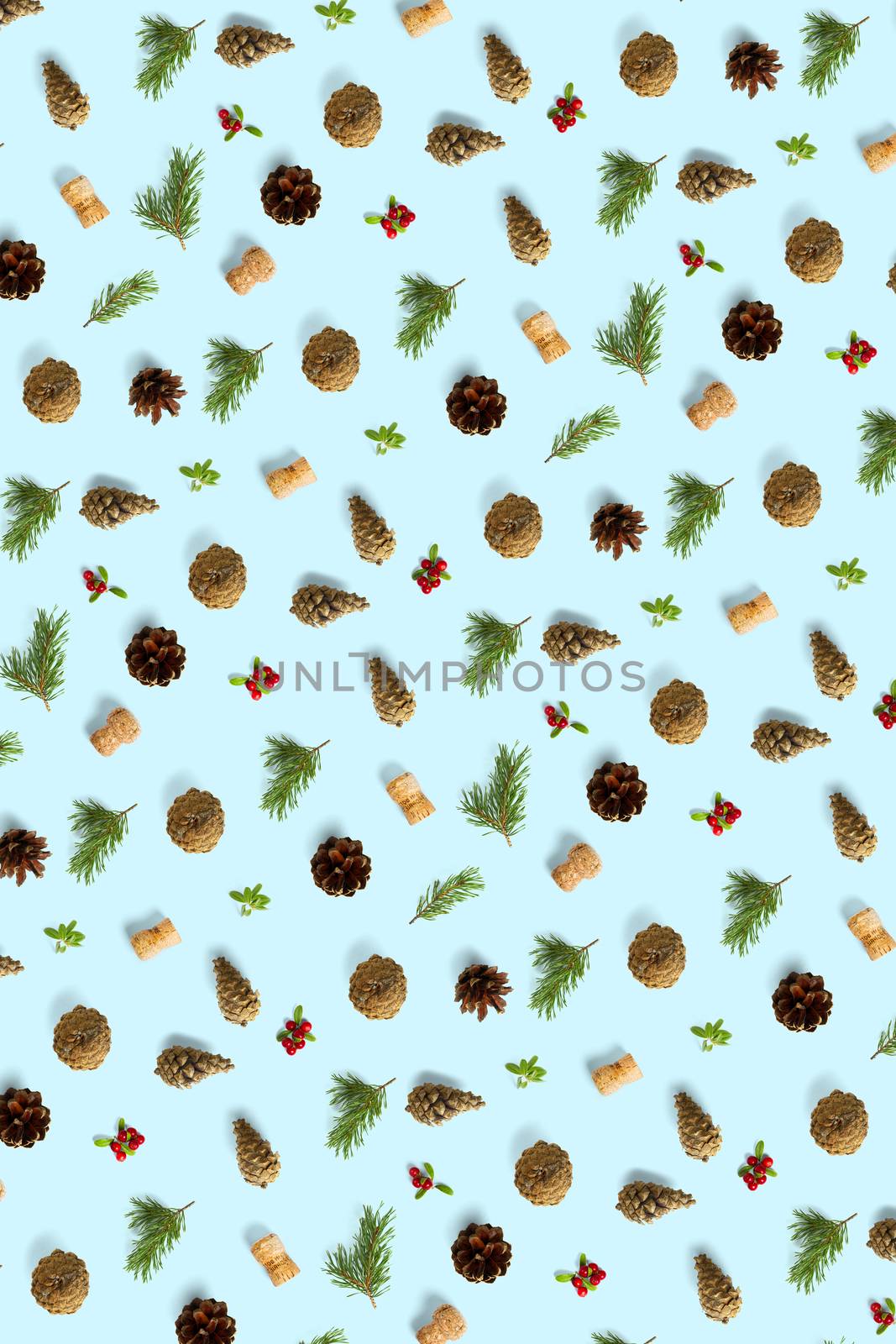 christmas background with pine cone, wine cork, pine twig and lingonberry. christmas background on blue backdrop
