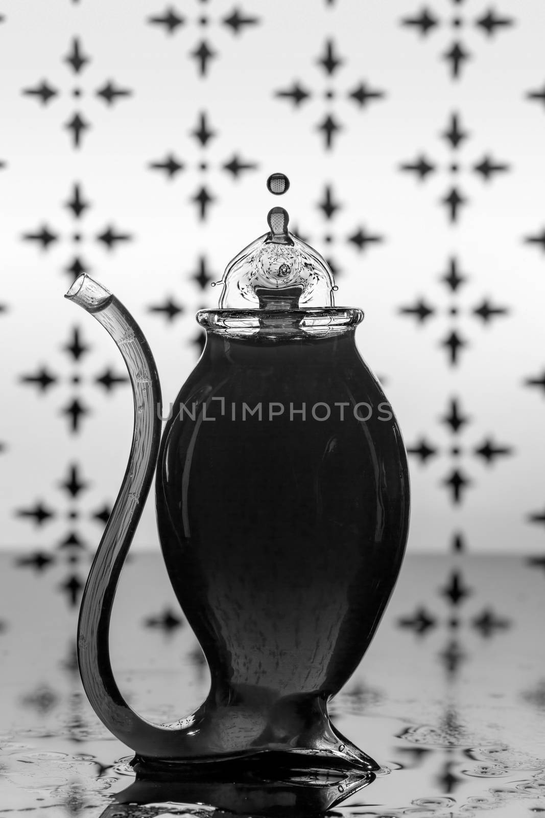 Water Drop Splashes To Create Shapes In A Port Glass by 	JacksonStock
