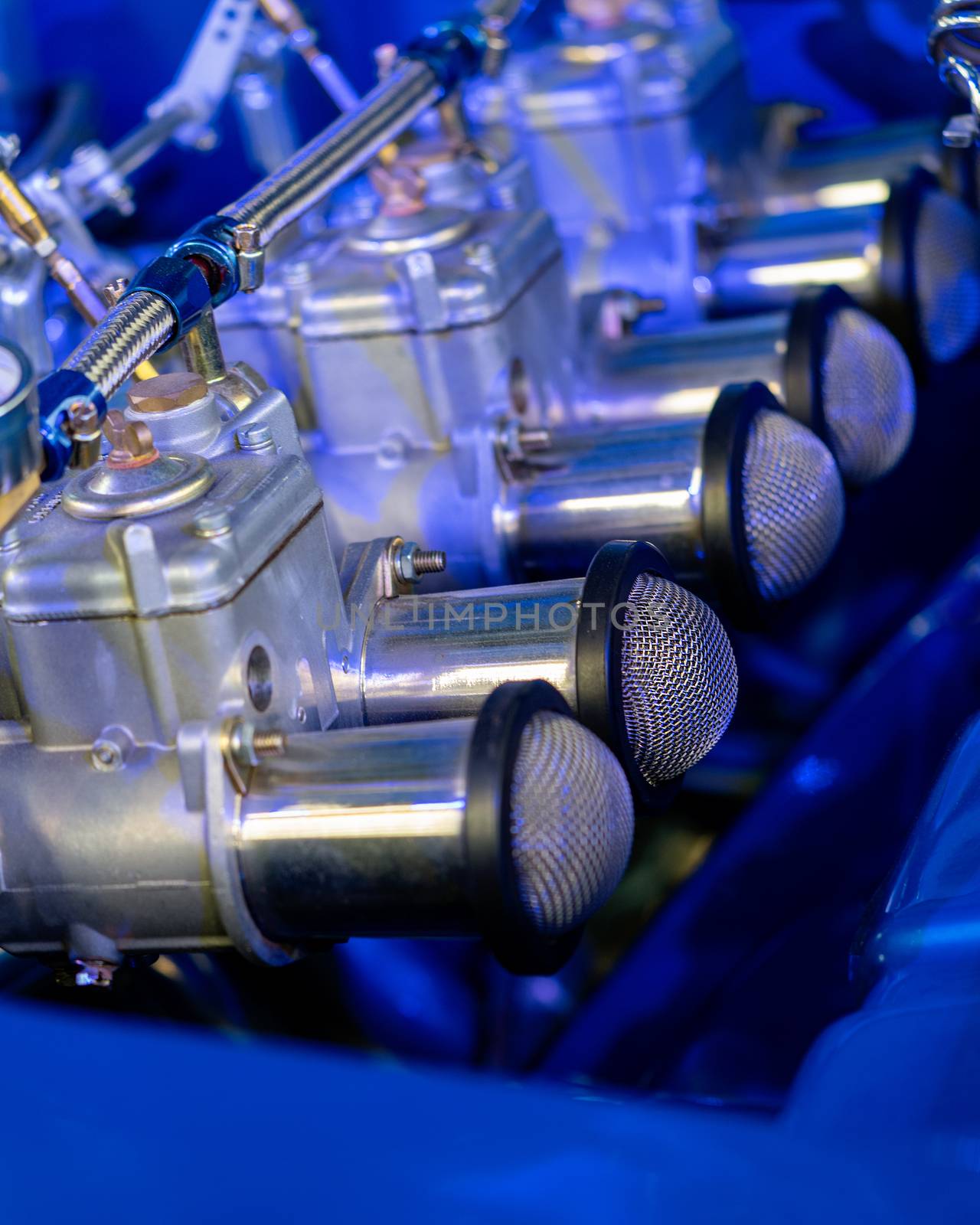 Close up of carburetor in engine of blue classic car