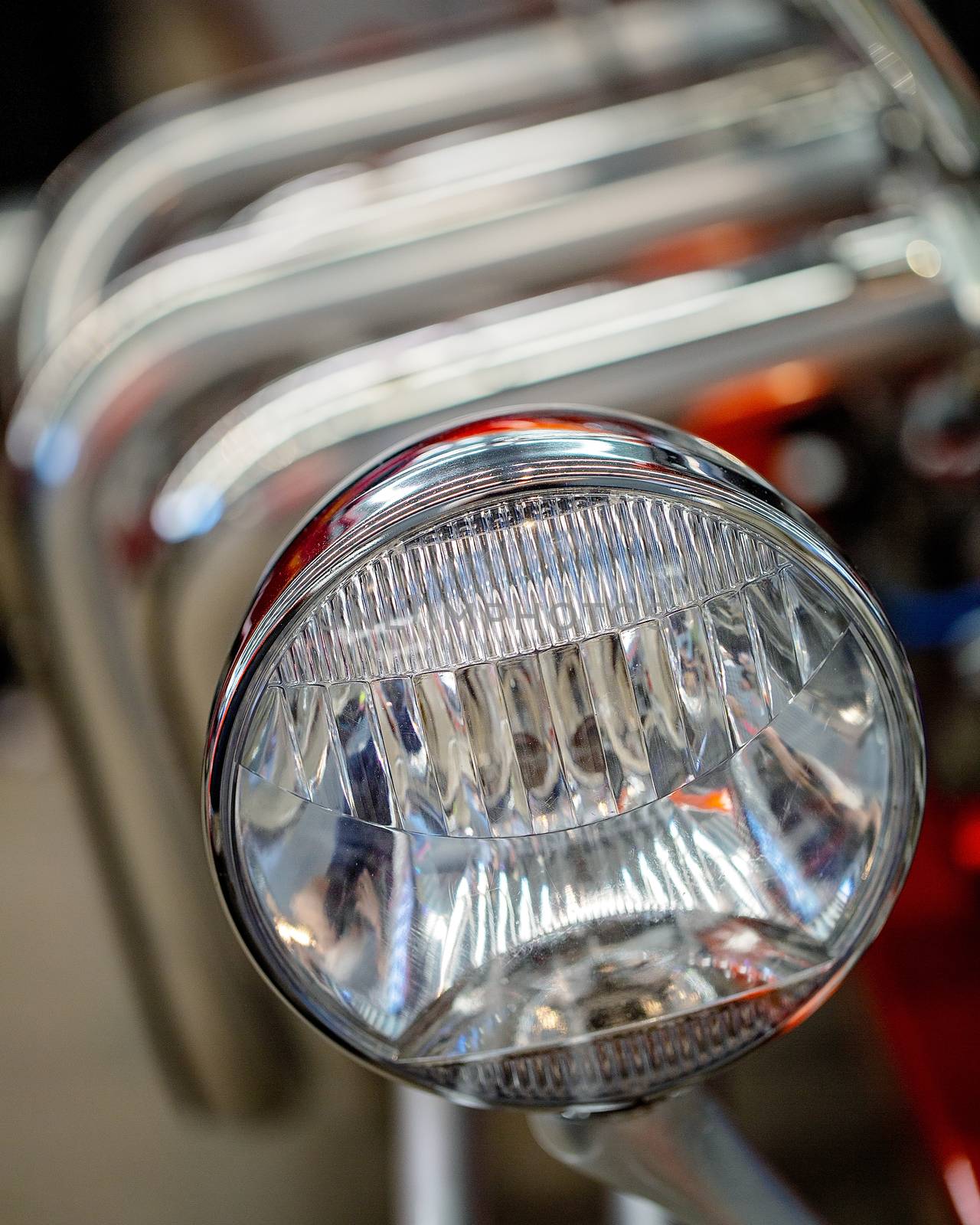 Close up of glass headlight of custom classic vintage car