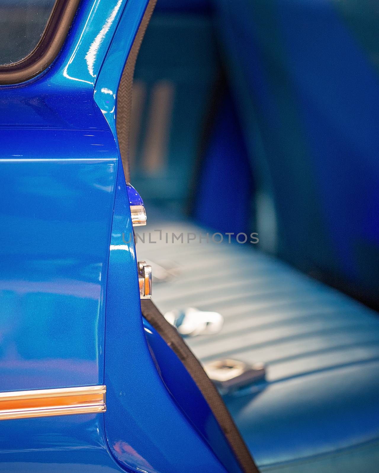 Close up of door and interior seats of blue custom classic vintage car