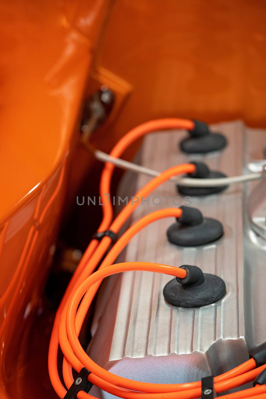 Close Up Of Engine Spark Plus Of Orange Classic Car by 	JacksonStock