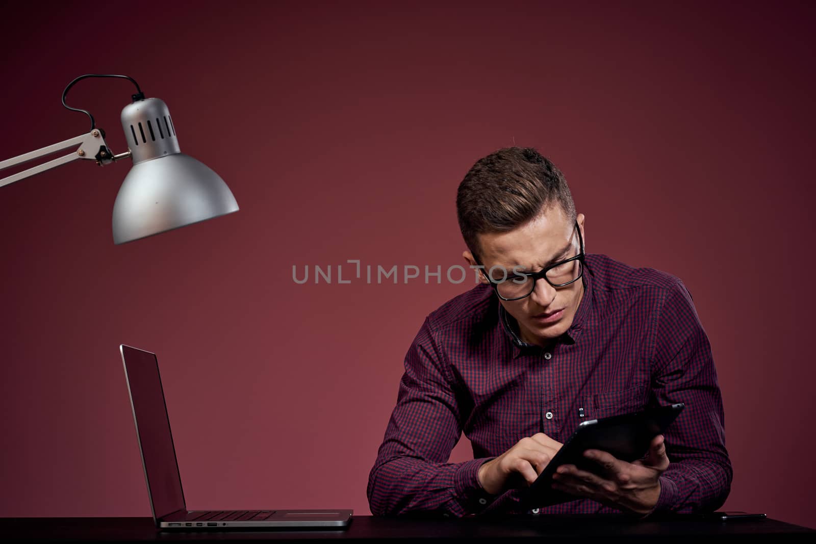 business man with laptop in office computers manager communication red pattern background. High quality photo