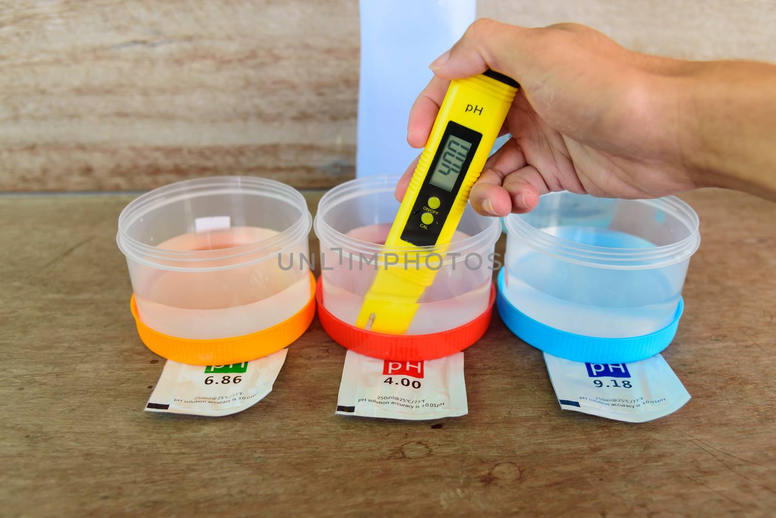 The man calibrate Ph meter before use it for tester