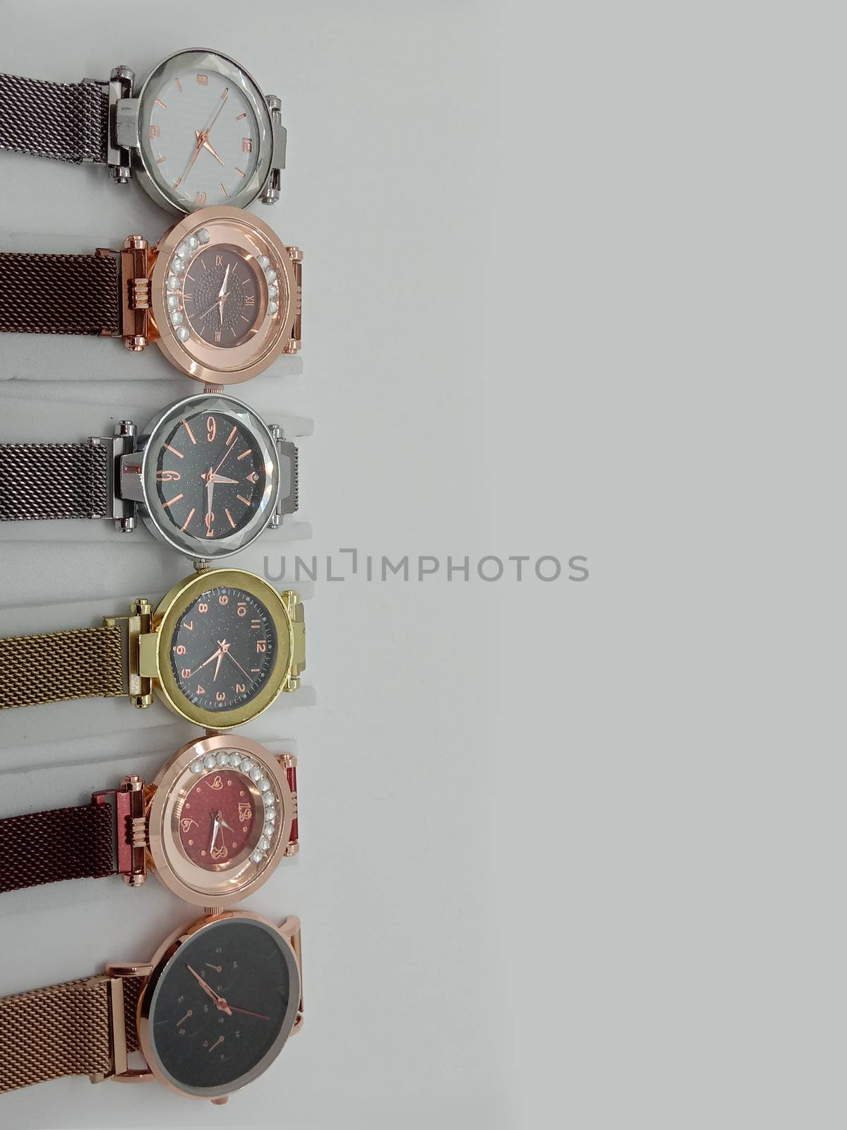 Multiple colored watch stock on gray background