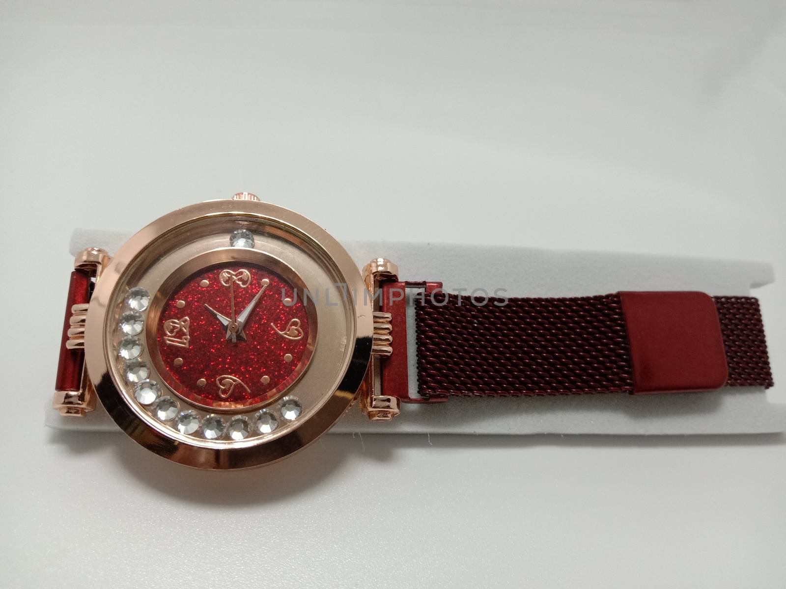 red colored watch closeup on gray background